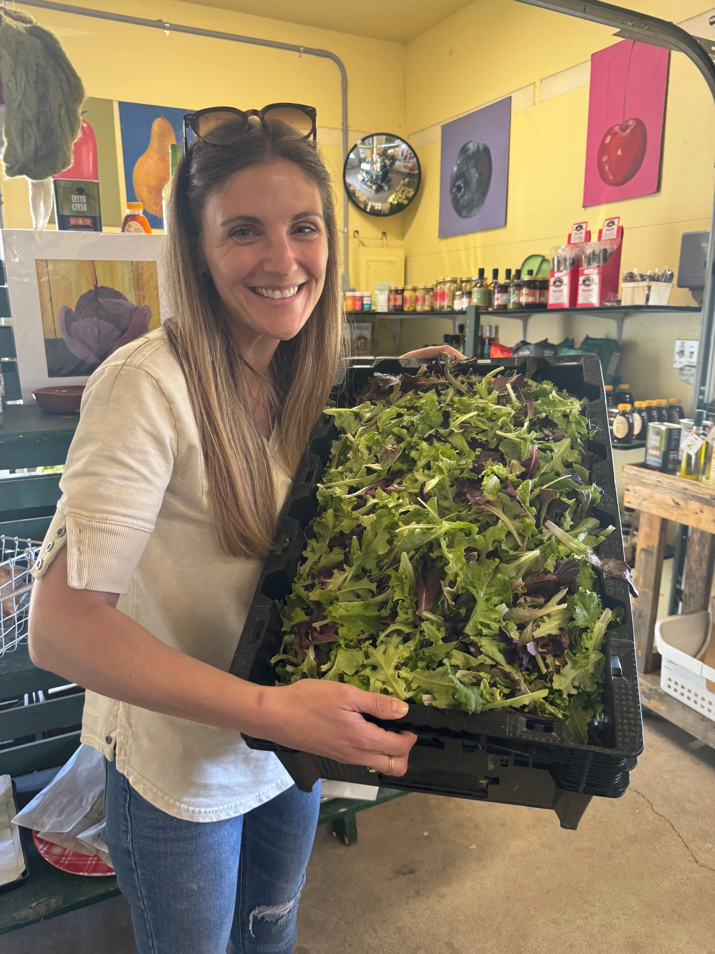 Carly Migliorelli Holding Greens at Market
