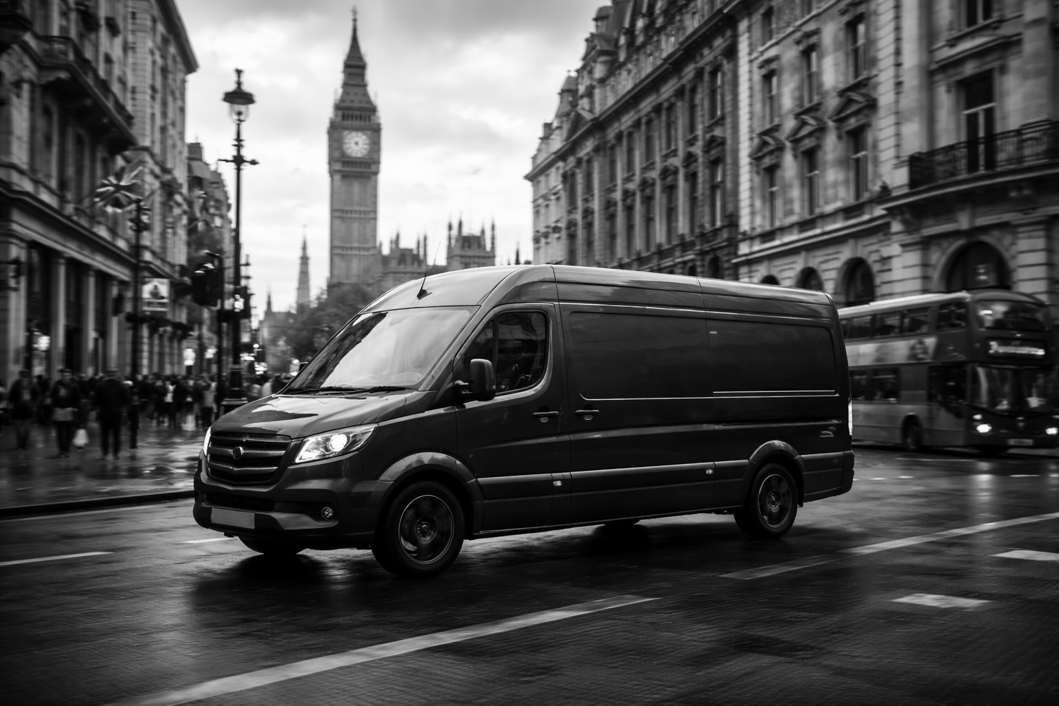 A black delivery van driving on a wet city street with Big Ben and historic buildings in the background, in black and white.