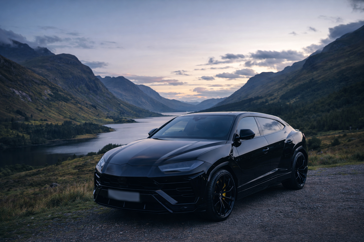 Black luxury SUV parked on a gravel path overlooking a scenic mountain lake at dusk with cloudy sky.