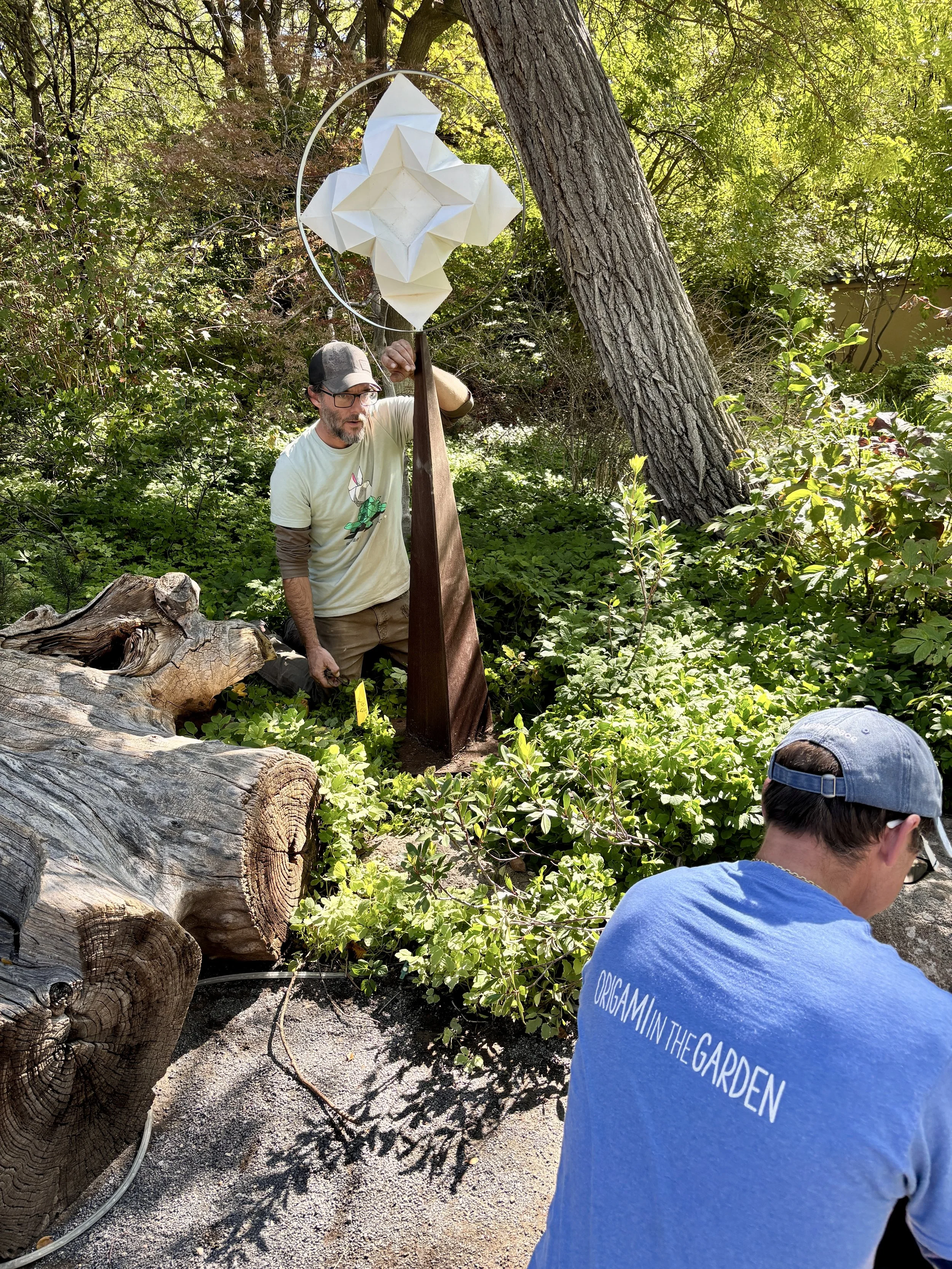 Staff installs a white metal star sculpture called Star Unfolding by Kevin Box at the ABQ BioPark Botanic Garden in Albuquerque.