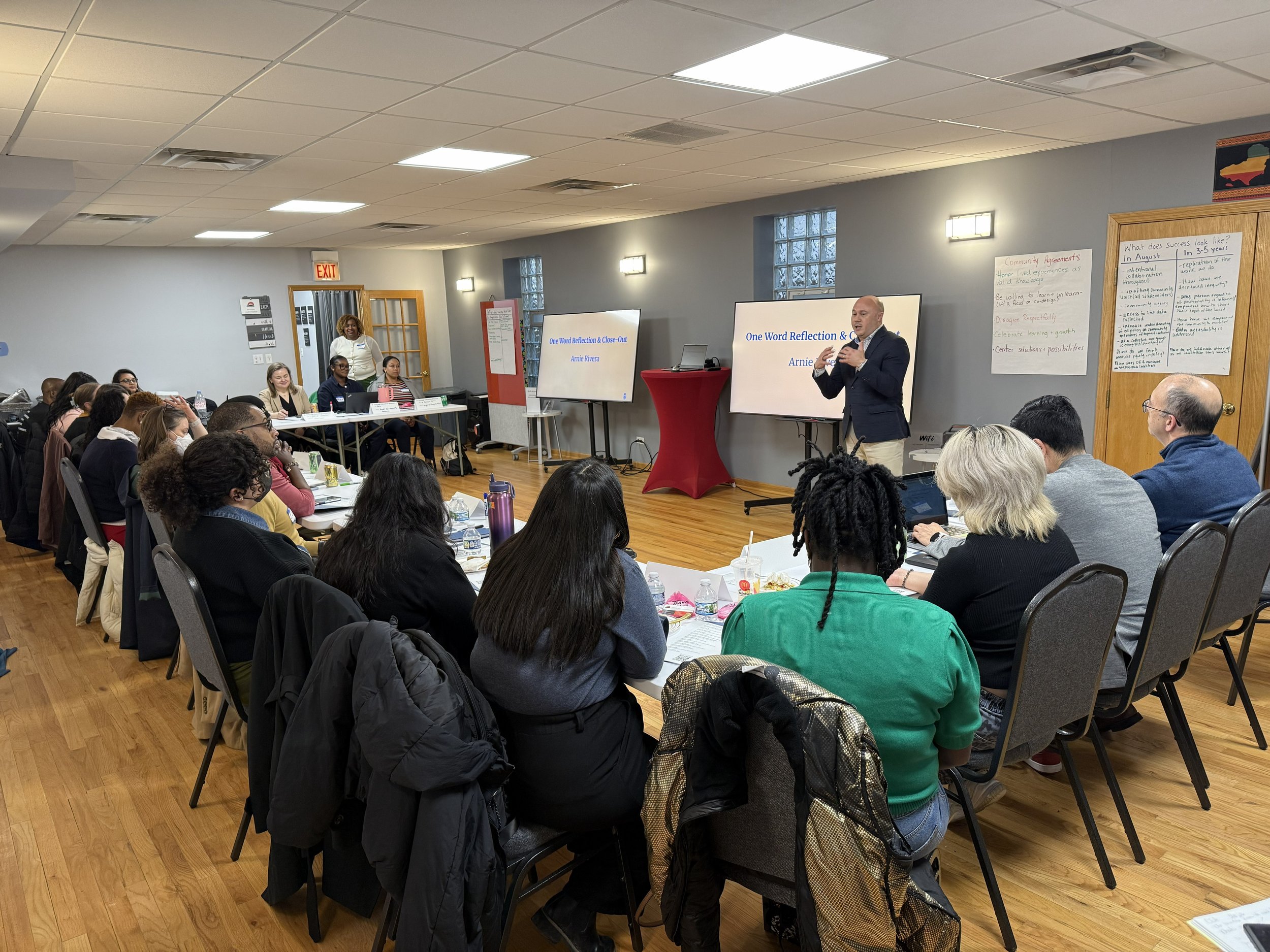 Co-Design Team Group listening to a presentation