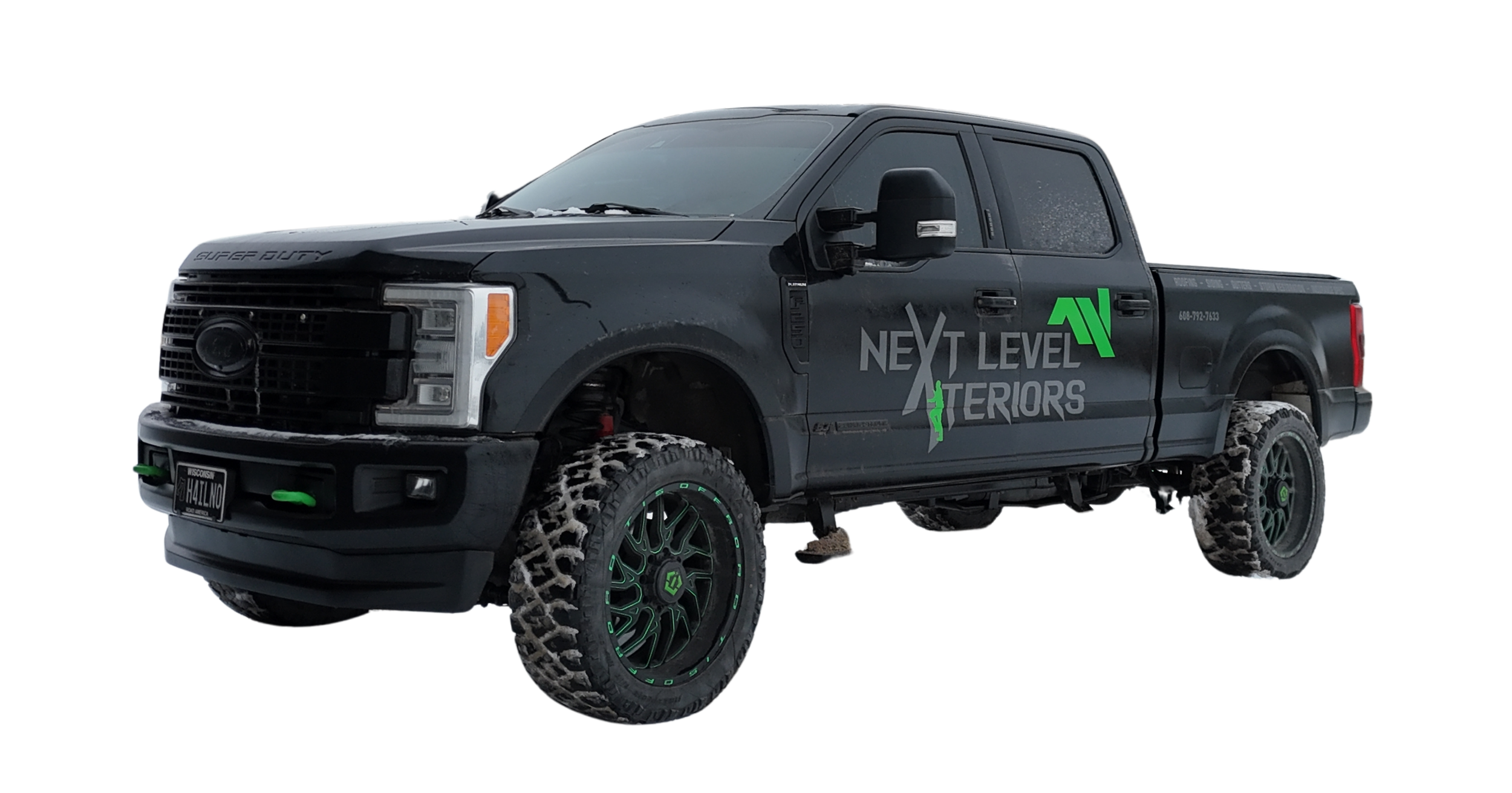 A black pickup truck with aggressive off-road tires and green accents. The truck has branding on the side that reads 'Next Level Interiors' with a lightning bolt logo. It has a black front grille, black side mirrors, and a license plate from Wisconsin.
