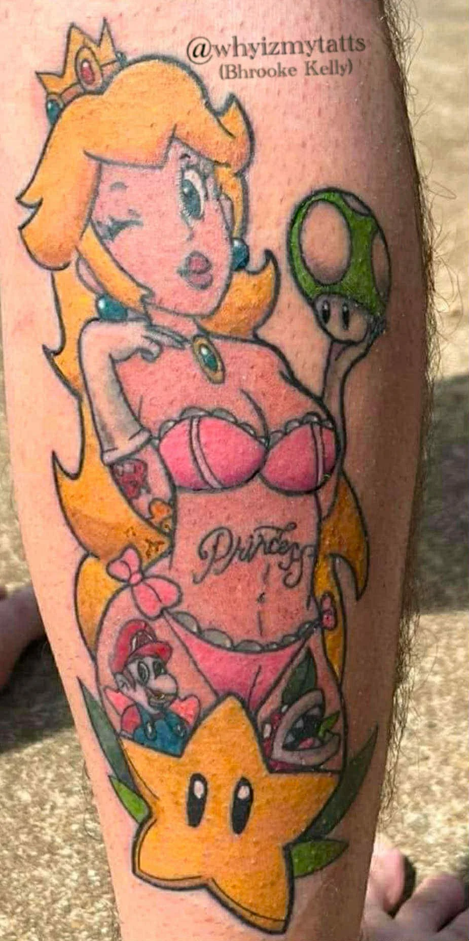 A tattoo depicting Princess Peach from Mario, holding a green Piranha Plant. The tattoo features a smaller version of Mario, a star, and the word 'Princess' written across her chest.