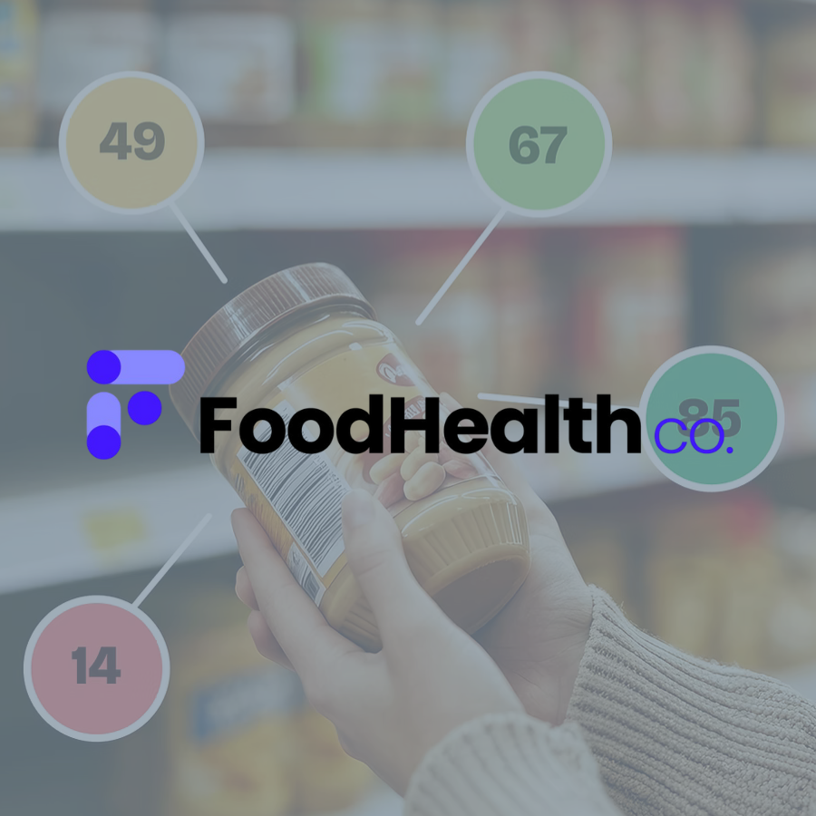 A hand holding a jar of peanut butter in a grocery store aisle.