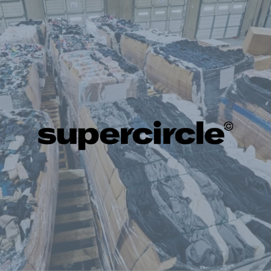 Stacks of plastic-wrapped clothing or fabric in a warehouse.