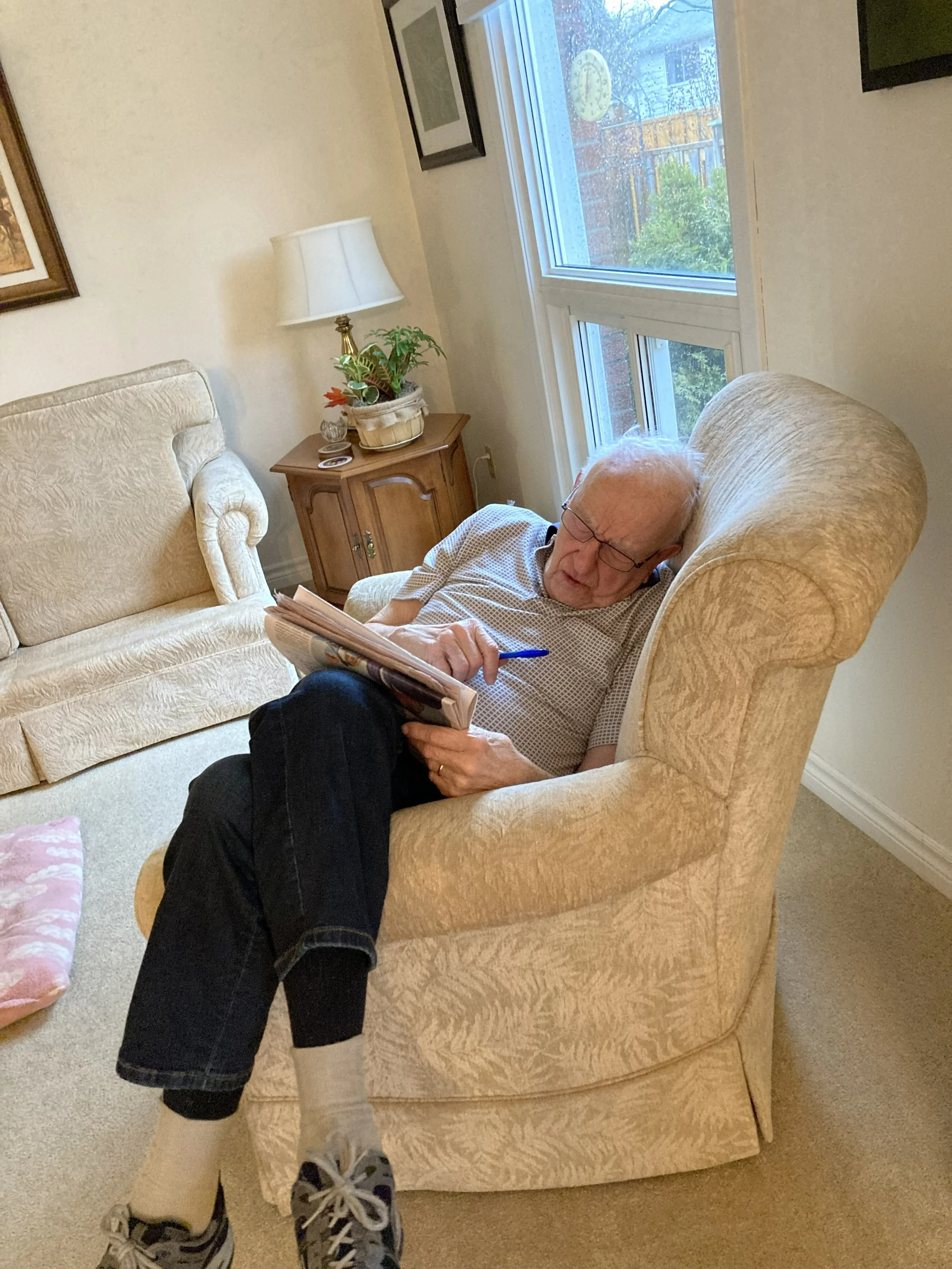 elderly man napping in puffy arm chair