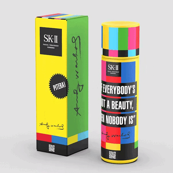 Colorful SK-II Facial Treatment Essence bottle with a multicolor pattern and a corresponding box, featuring the quote 'Everybody's not a beauty, even nobody is' and a signature.