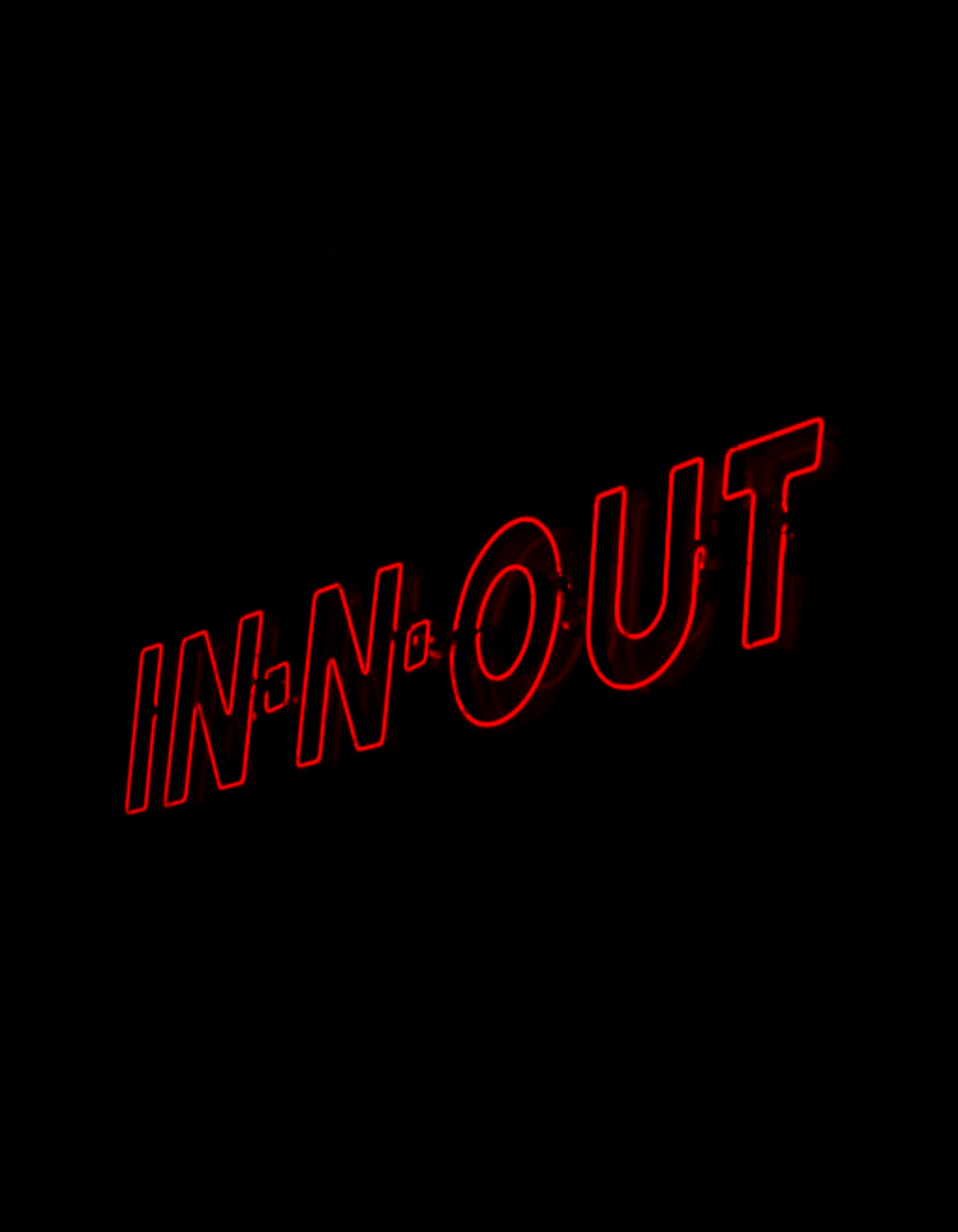 Red neon sign reading 'IN-N-OUT' against a black background.