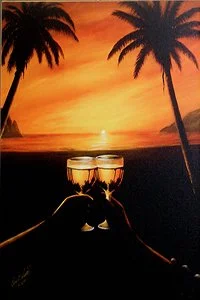 A sunset on the beach with two glasses of champagne and palm trees in the foreground.