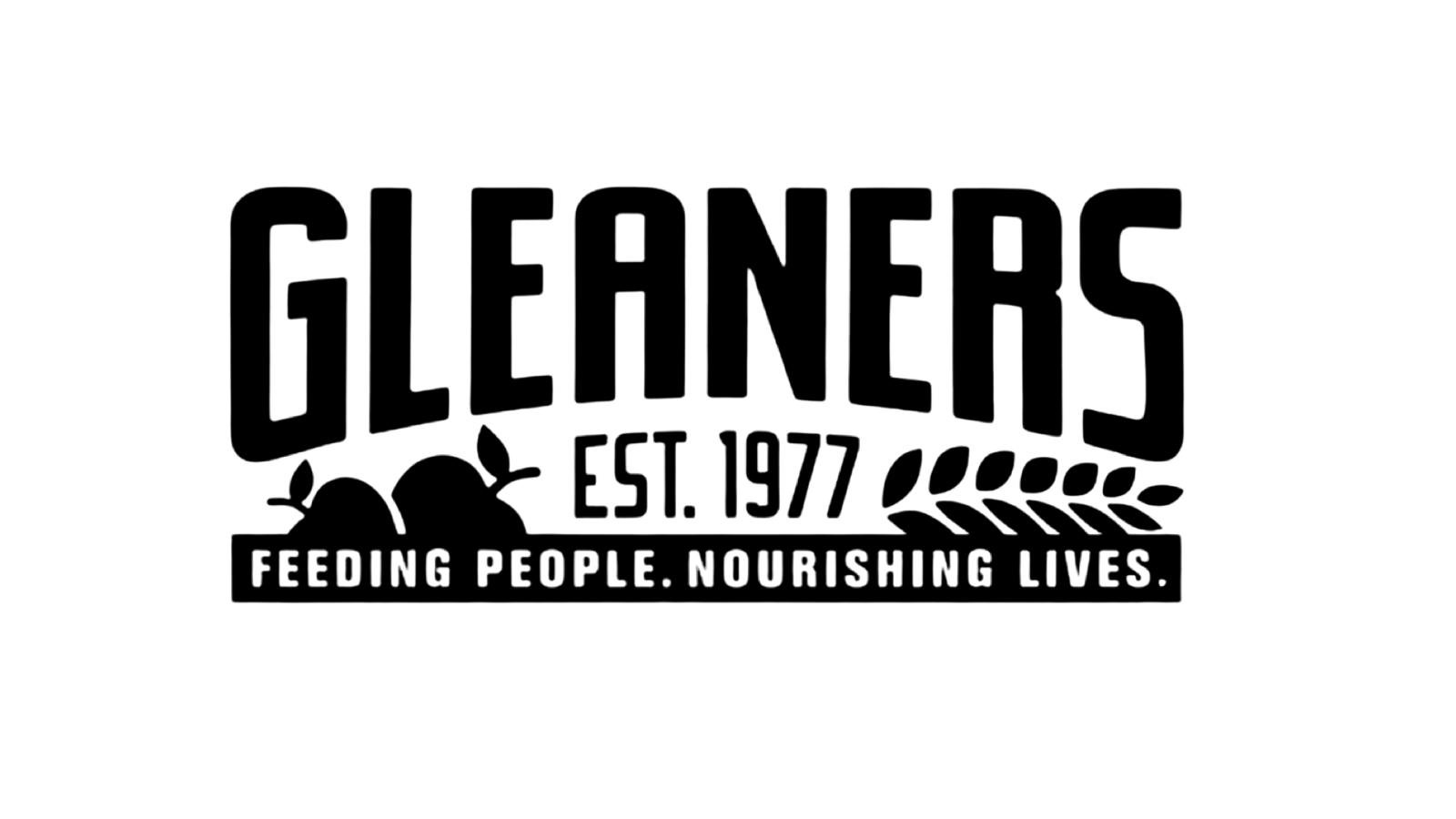 Black and white logo of Gleaners with the text "Gleaners Est. 1977" and the tagline "Feeding People. Nourishing Lives." accompanied by illustrations of vegetables and leaves.