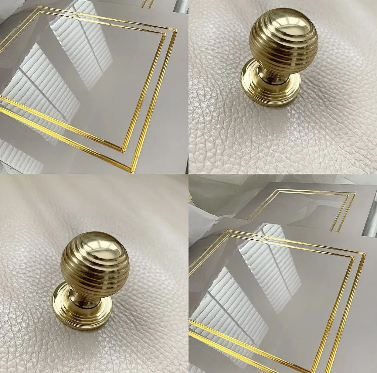 Close-up view of a gold door knob and gold trim on a reflective glass surface, with a textured light-colored background.