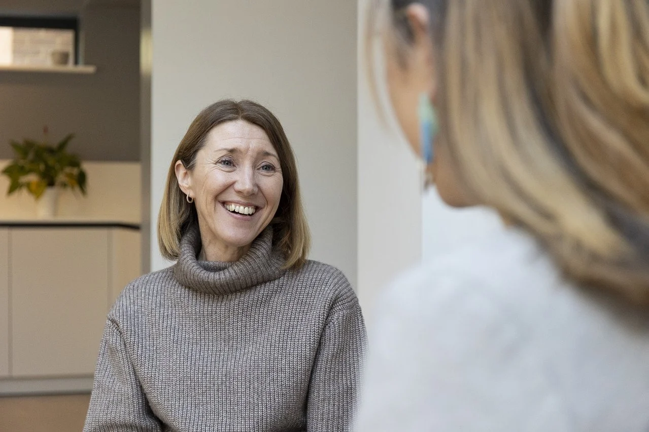 Kirsty Murdoch coaching a mid-career professional female client who is looking relaxed and smiling.