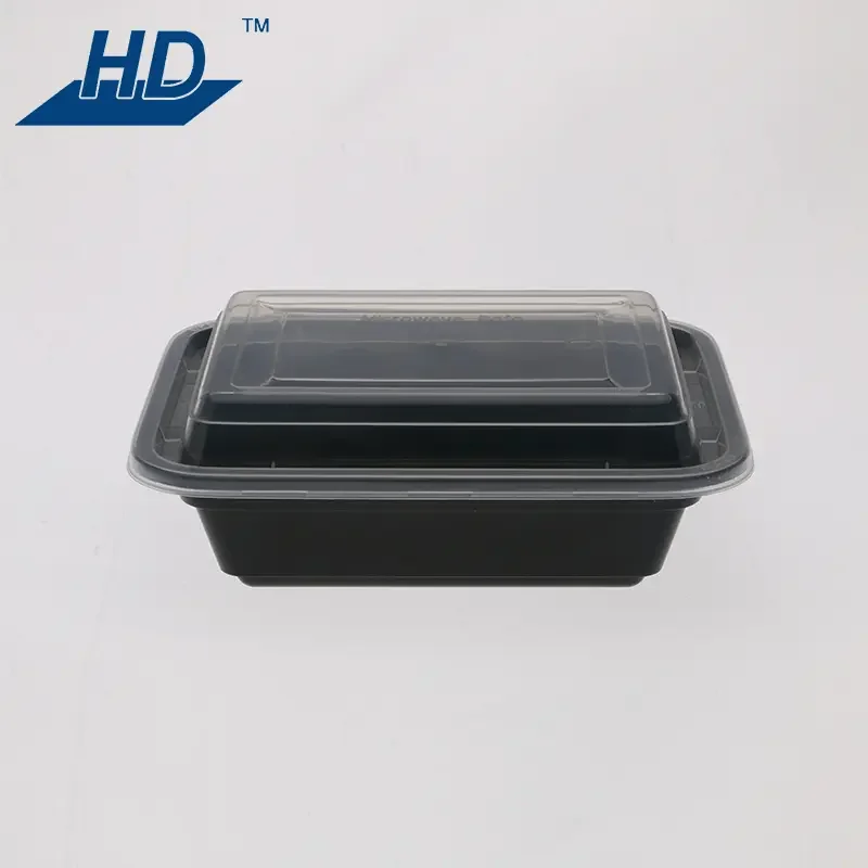 Black plastic food container with a clear lid on a white background.