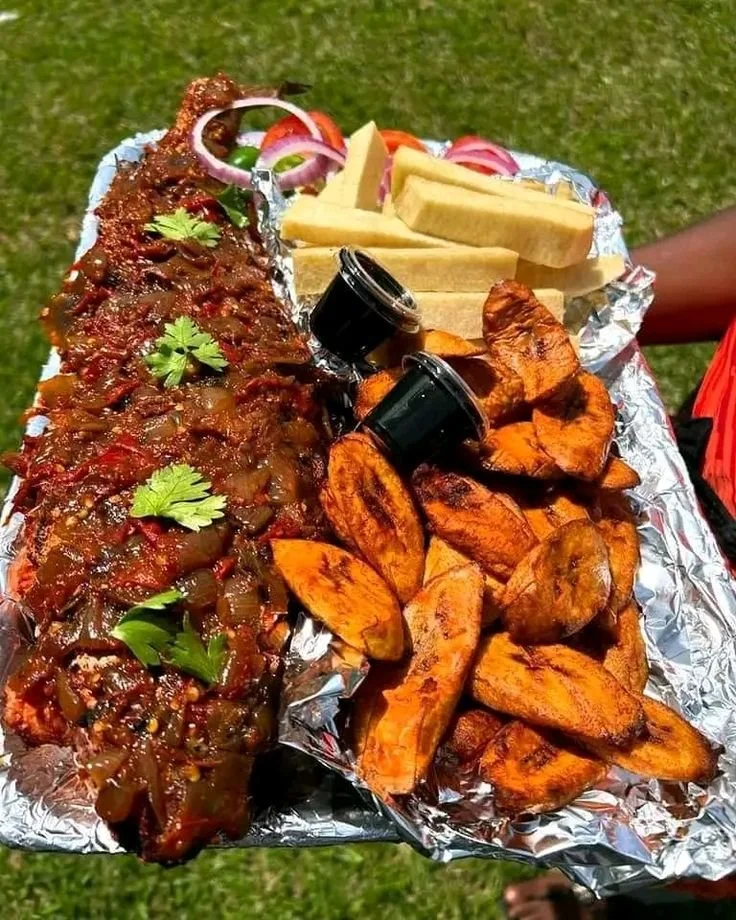 Grilled Tilapia Fish Platter with fried plantain, yam chips.