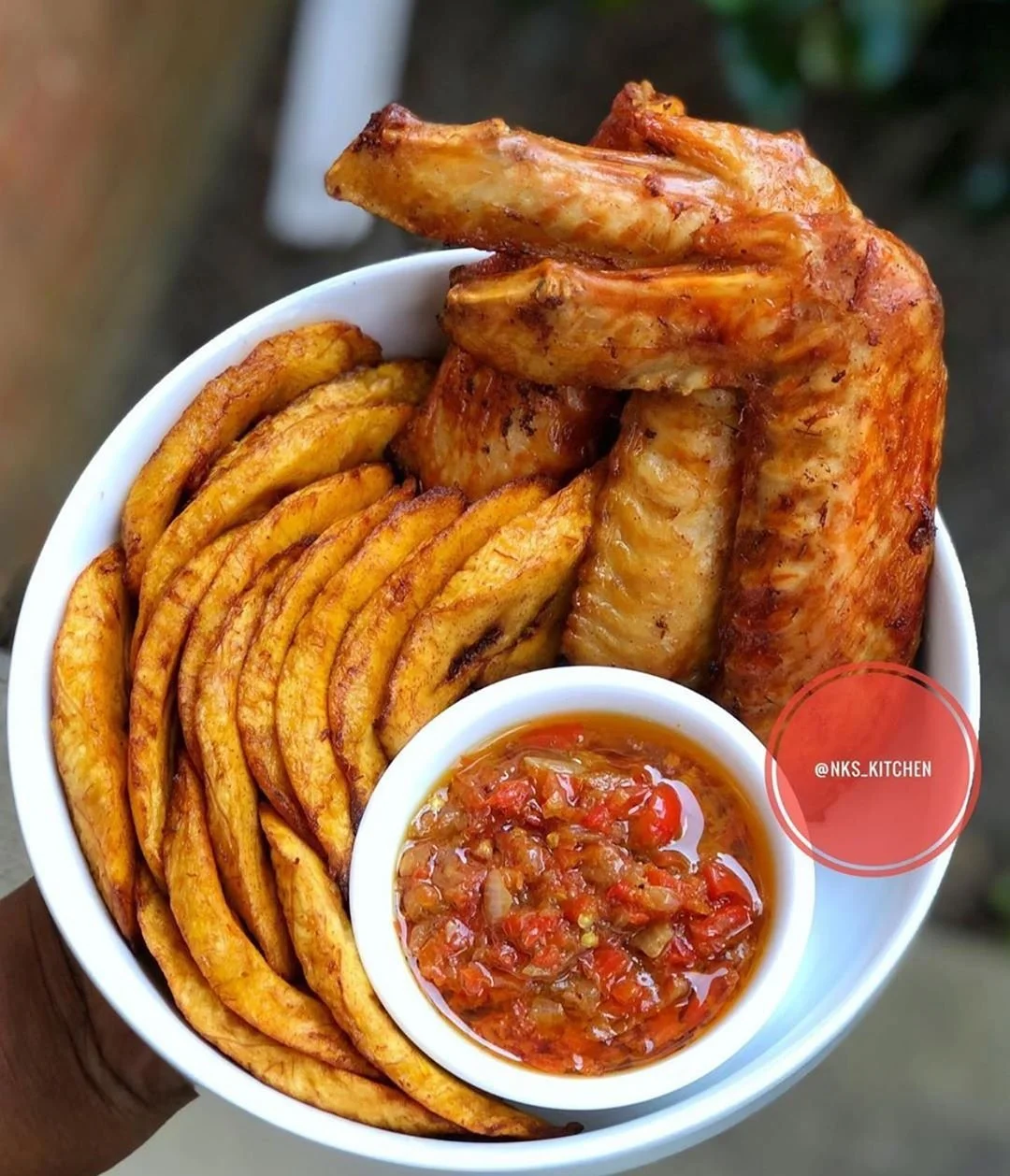 Peppered Grilled Turkey Platter with fried yam chips, small bowl Jollof rice and plantain