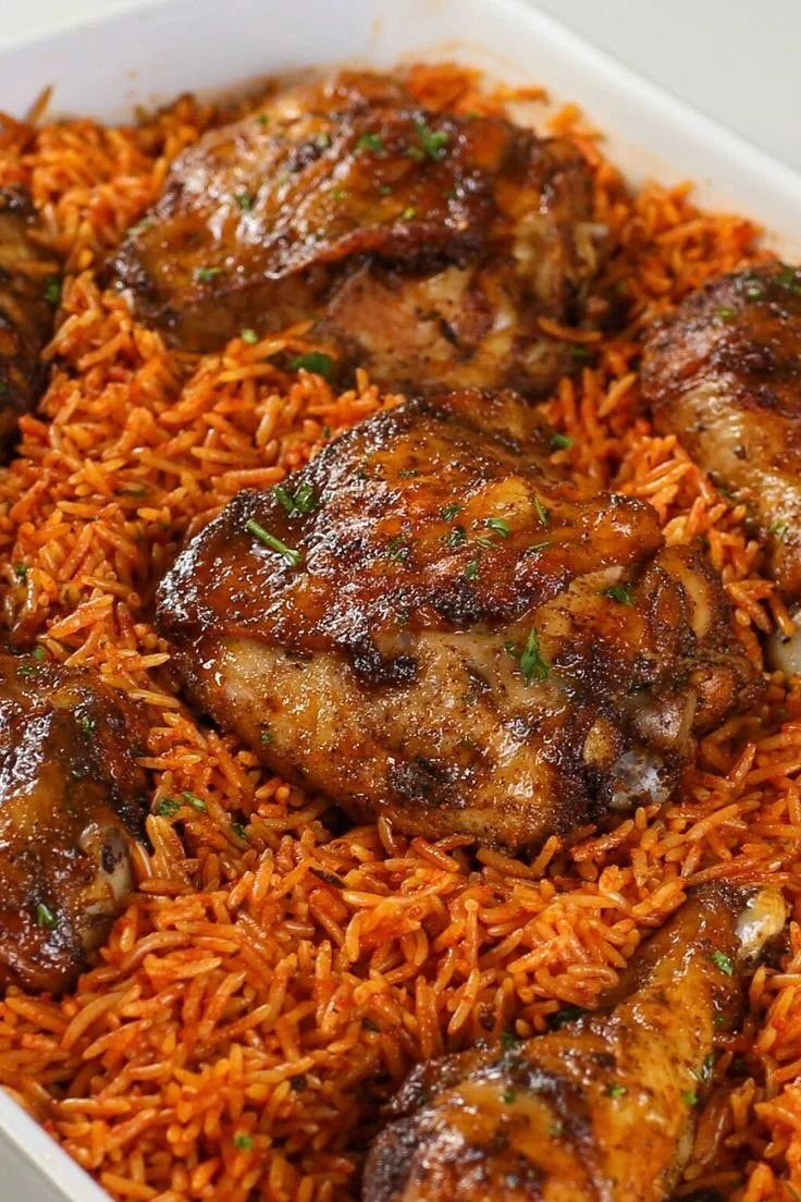 Smoky Party Jollof Rice served with grilled chicken, Turkey or Grilled fish