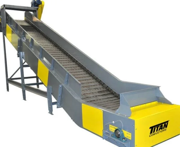 A large industrial conveyor belt system with metal rollers, painted yellow and gray, labeled Titan Conveyors.