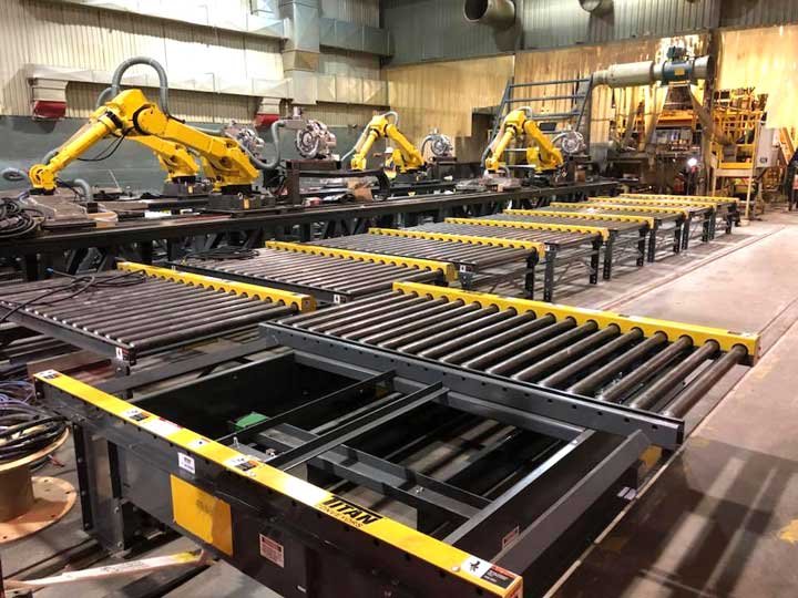 Industrial manufacturing setting with robotic arms assembling or manipulating materials on a conveyor system.