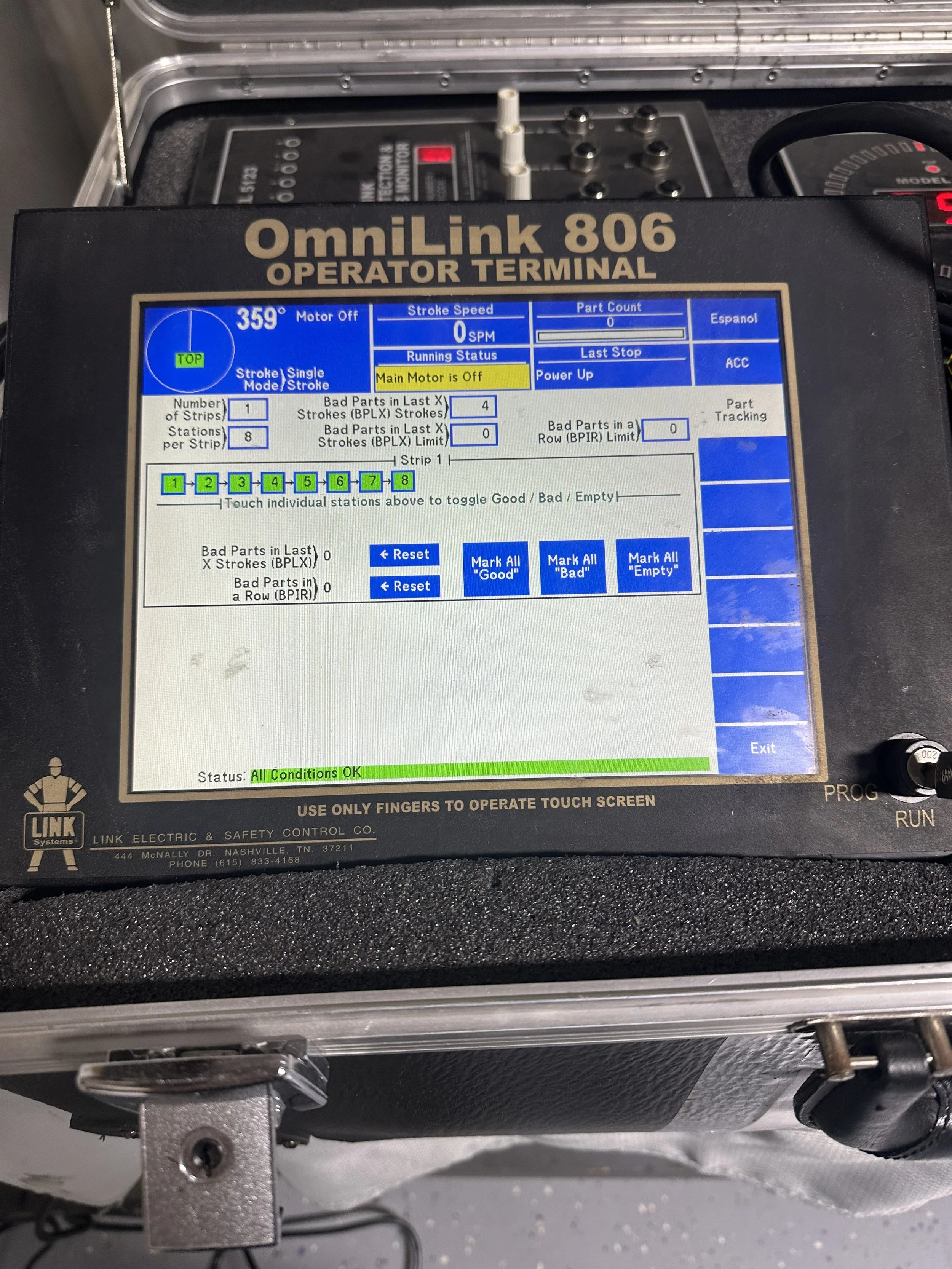 Touchscreen control panel for an OmniLink 806 operator terminal, displaying status of a machine with options to mark parts good, bad, or empty. The display shows machine status as "All Conditions OK" and the main motor off.