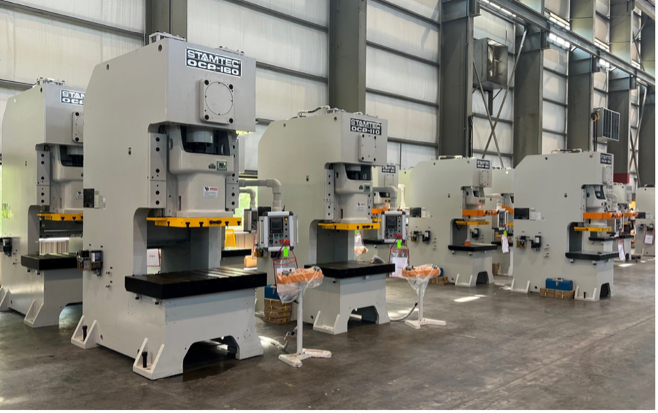 Multiple industrial stamping machines in a factory.