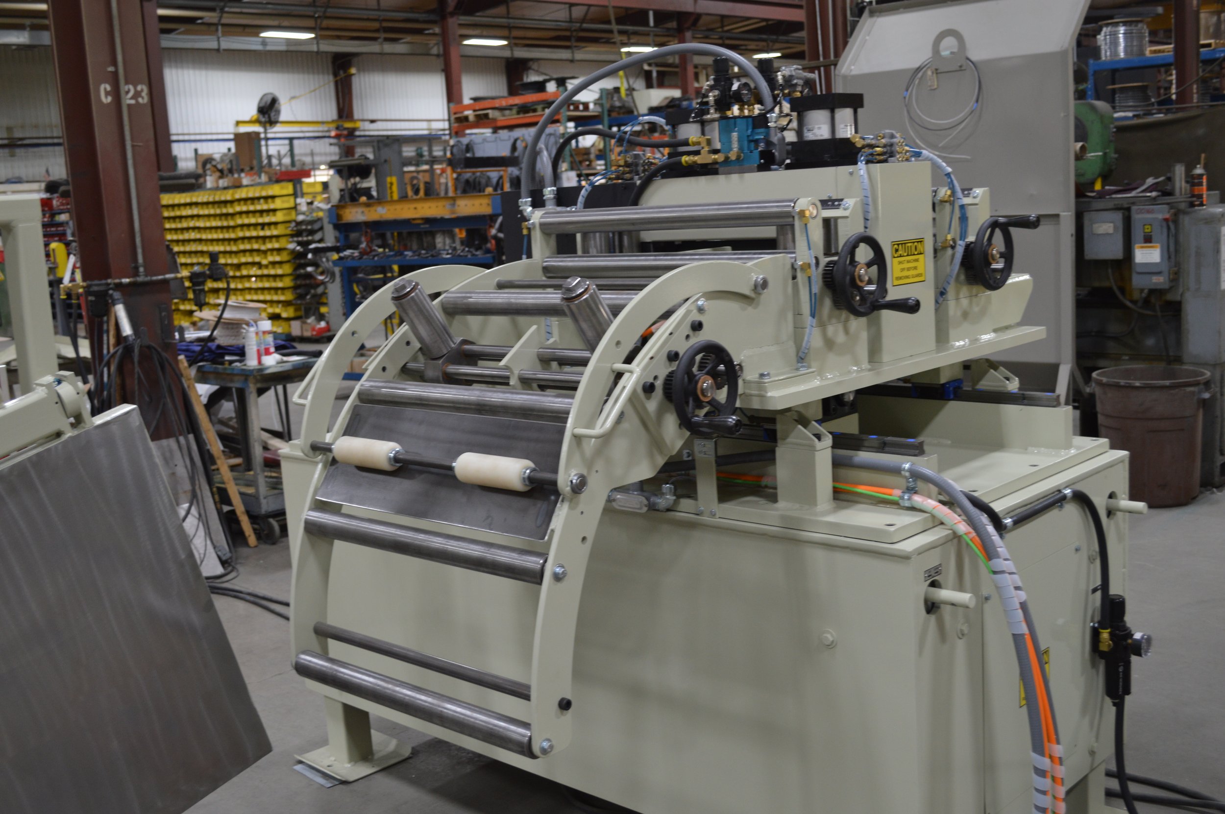 Industrial machine with rollers and gears in a manufacturing workshop