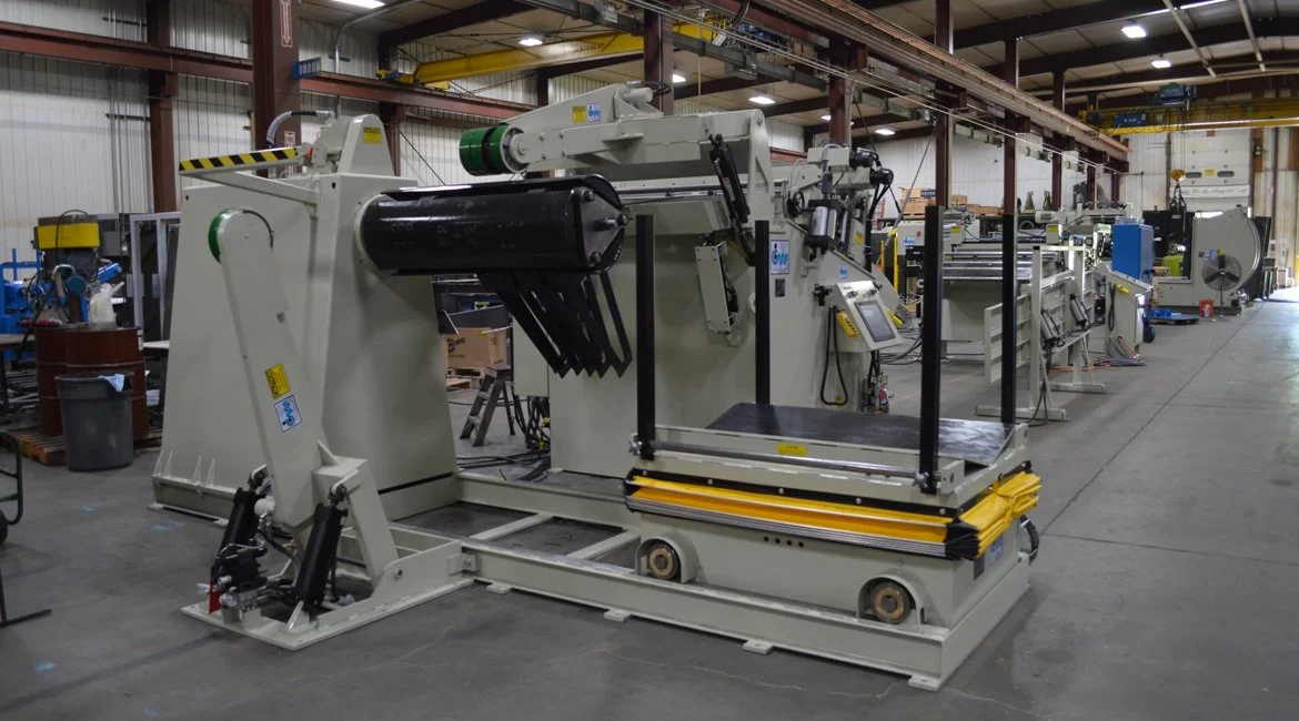 Industrial work platform and machinery in a factory setting with other equipment visible in the background.