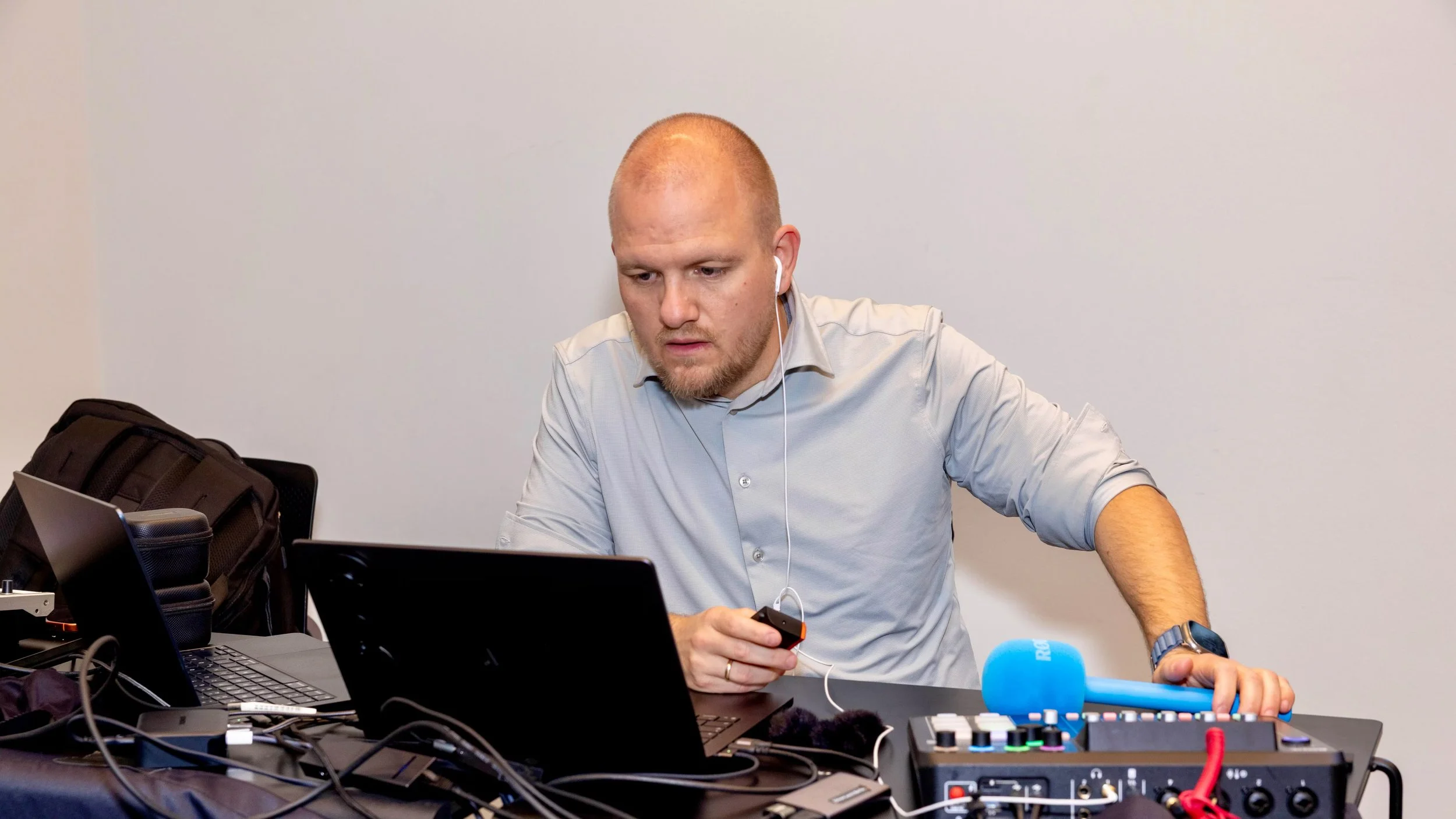 Producer in front of two laptops and an Audio mixer