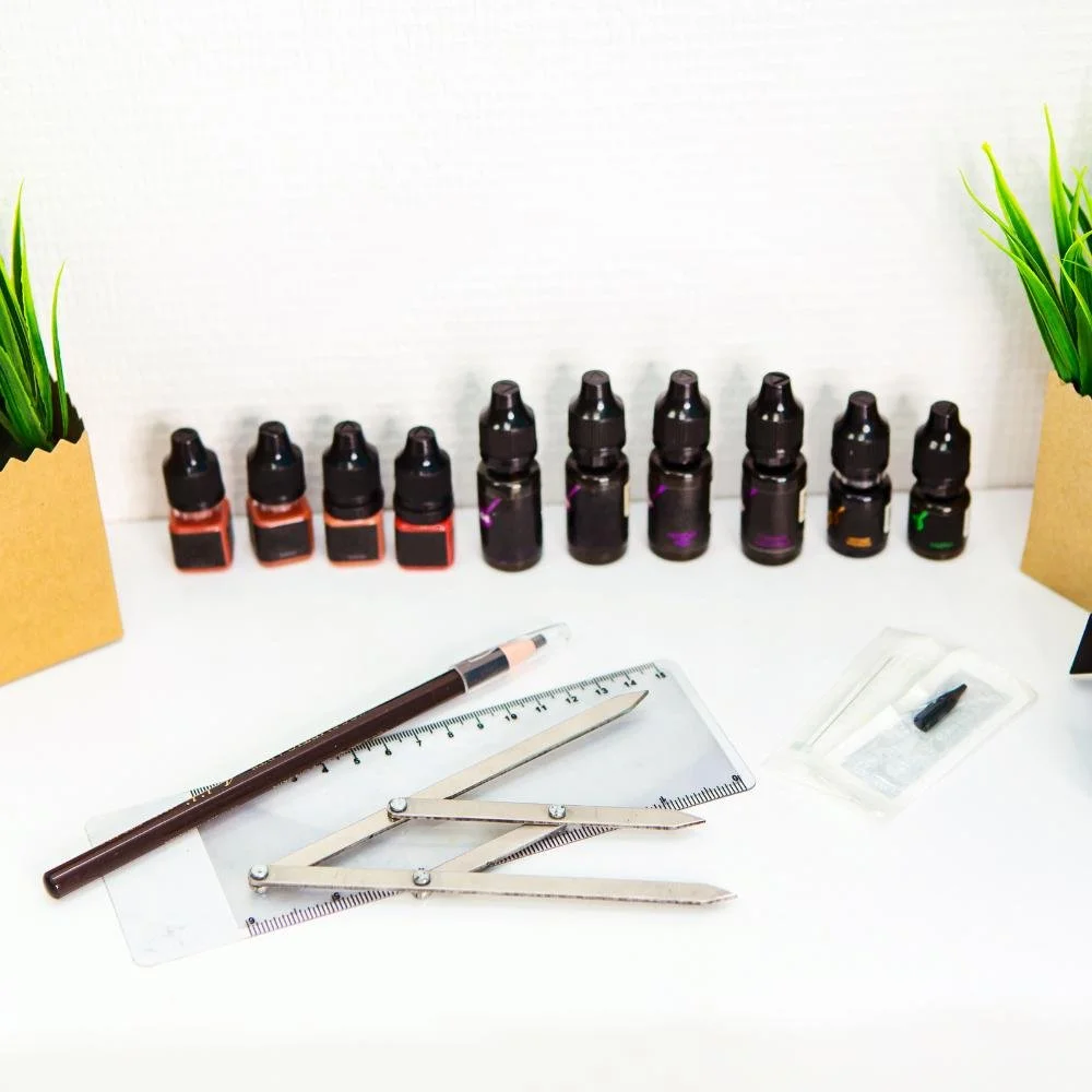 Professional permanent makeup pigments, tools, and sterile setup on white surface representing safe, hygienic practice.