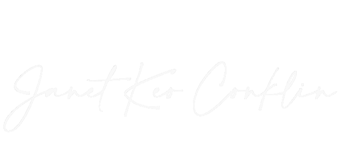 Handwritten text that reads 'Janet Keo Conklin' on a black background.