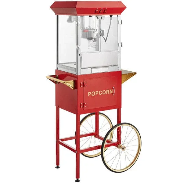 Red popcorn machine with gold accents, large wheels, and a glass enclosure for popping popcorn.