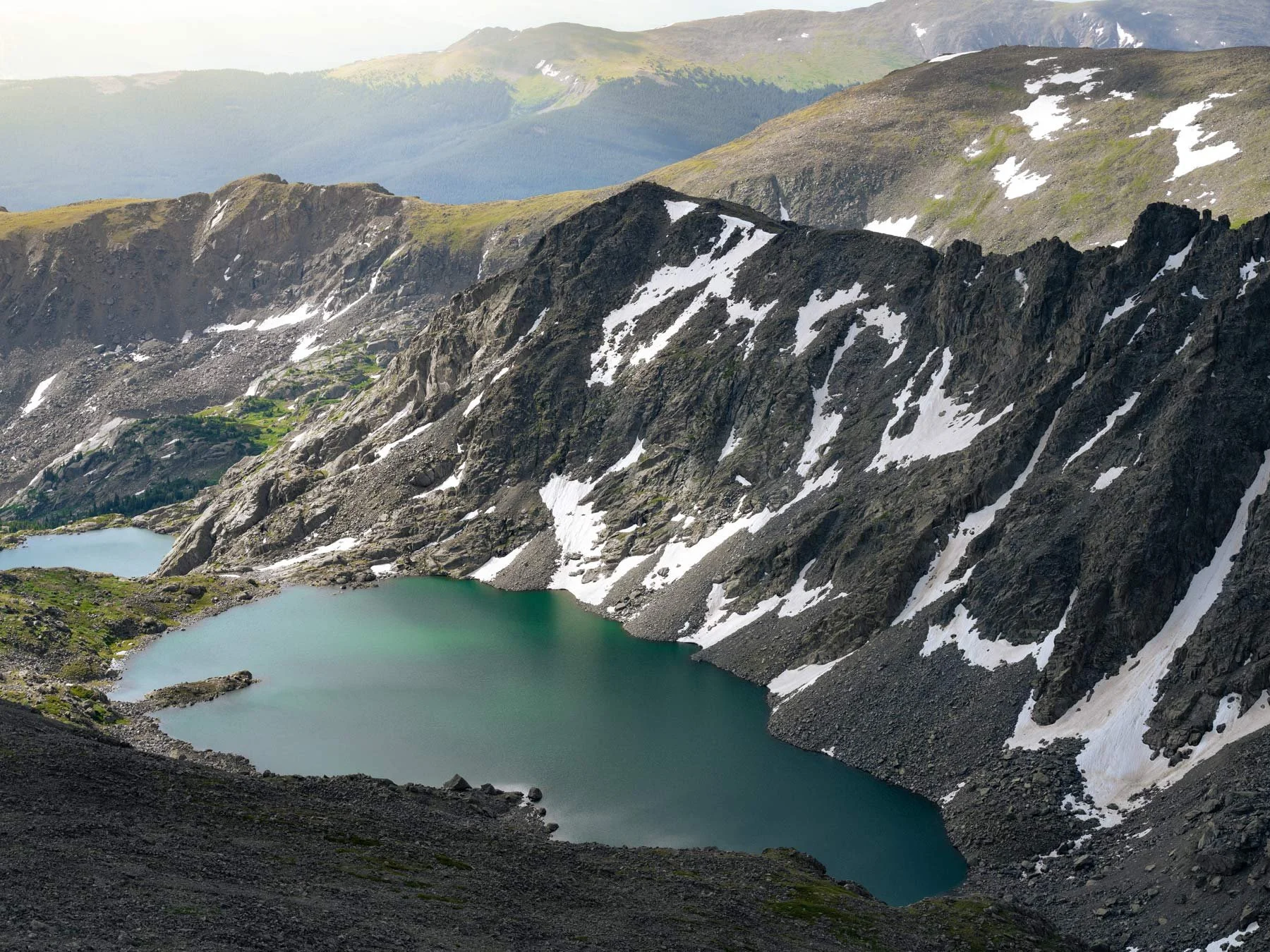 Aerial view of alpine lake with snowy mountains