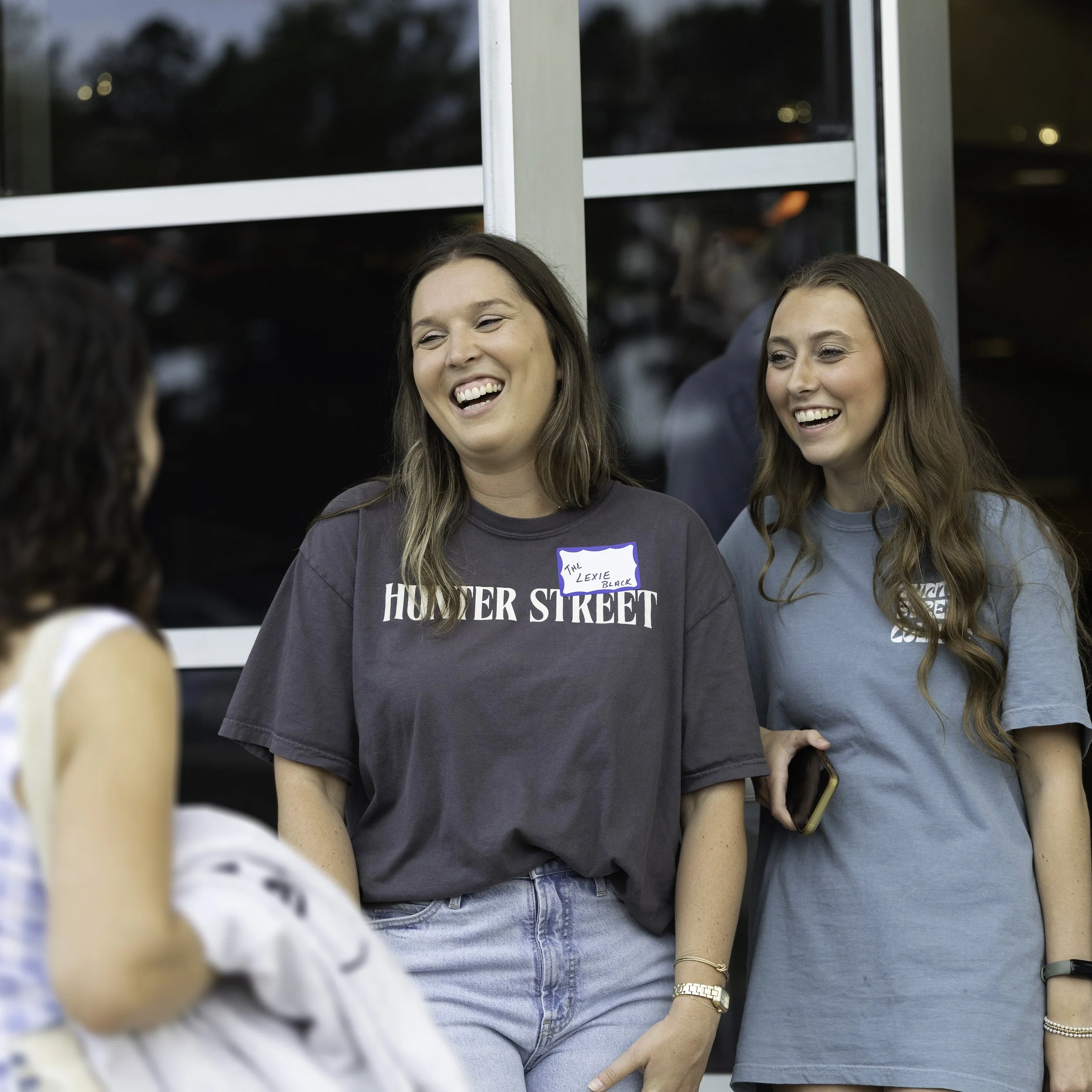 Young Adult volunteers greeting guests.