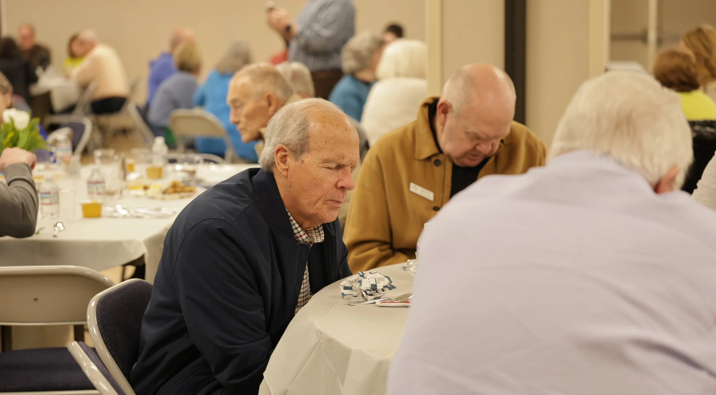 Senior Adults lifting each other up in prayer.