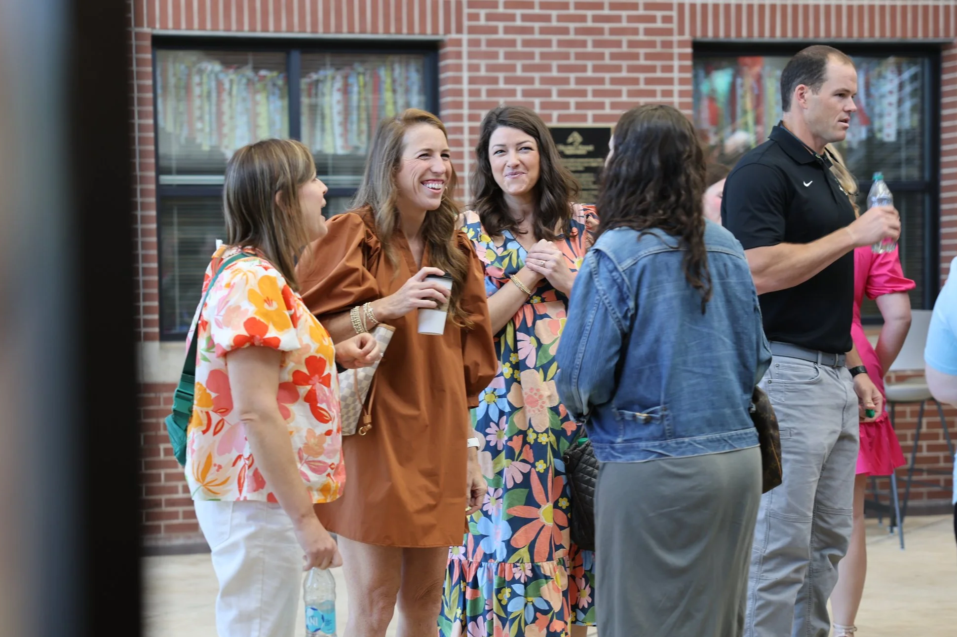 A group of women laughing and talking together at Hunter Street Baptist Church.