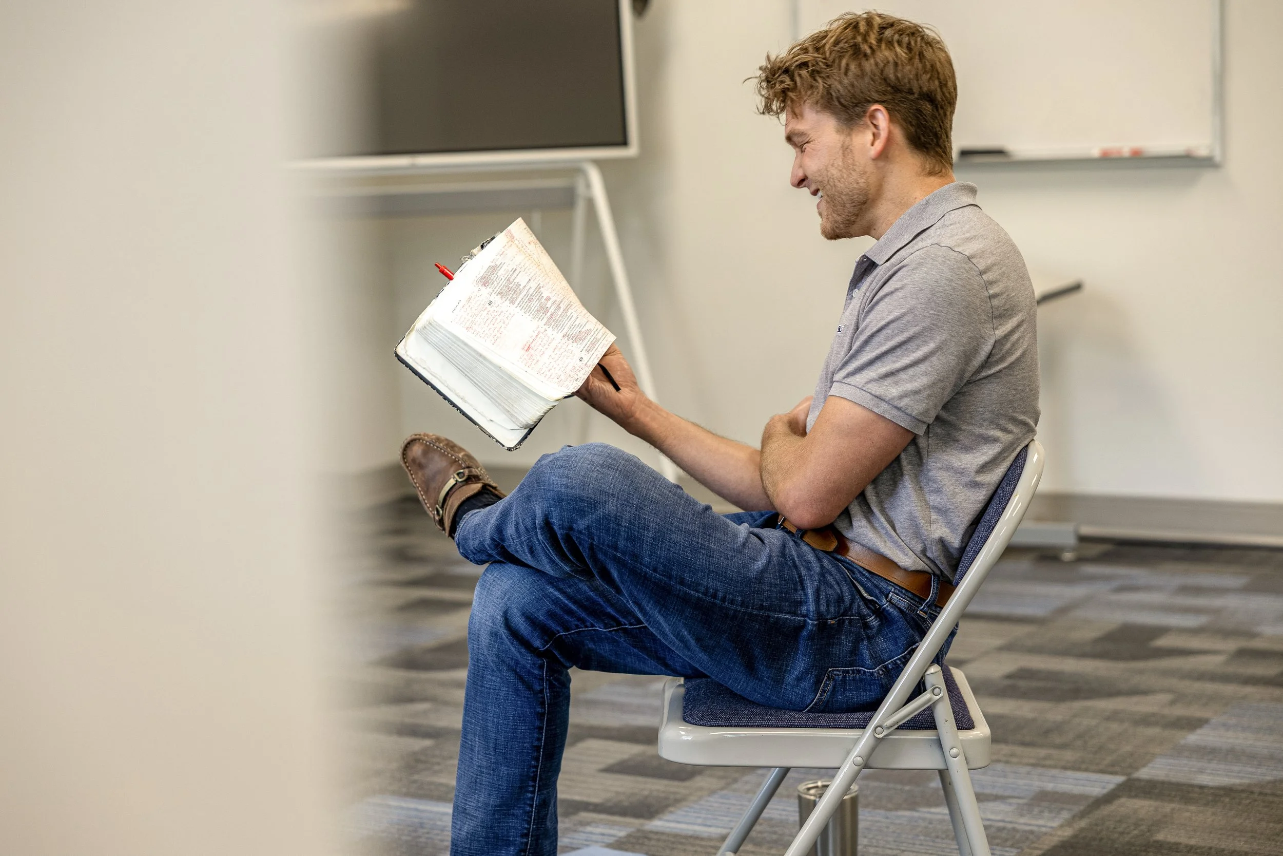 A Small Group leader reading Scripture to his peers.