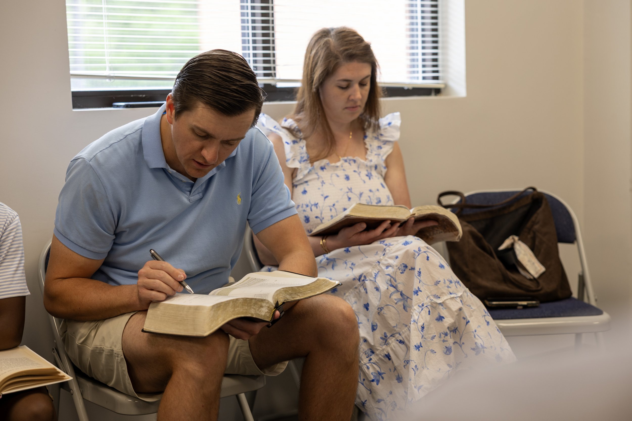 Adults reading Scripture together in their Small Group.