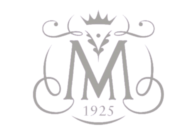 A decorative emblem with a large letter M at the center, a crown on top, and the year 1925 written below.