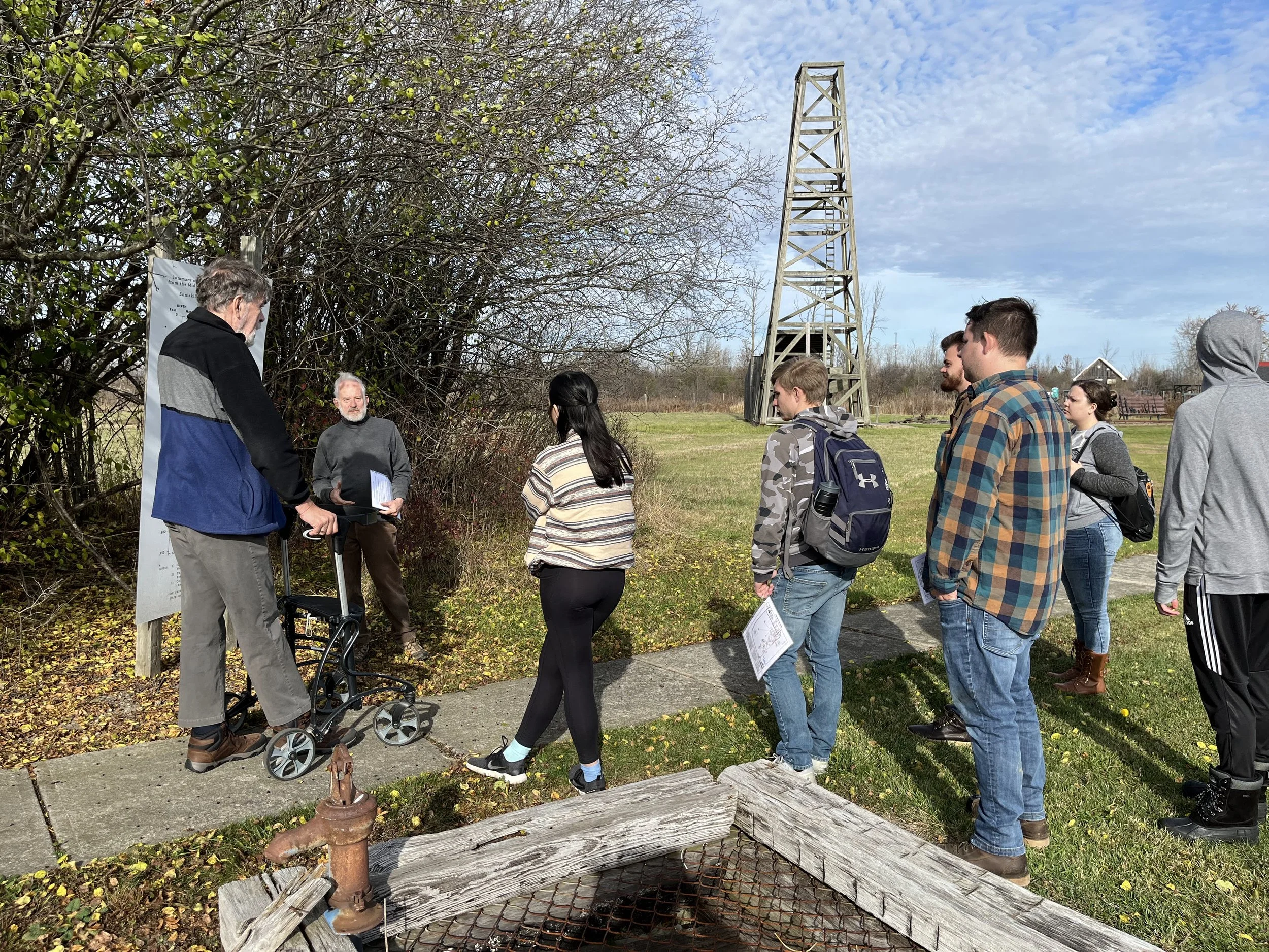 OU students learning about geology of oil field with Oli Rig in the background.jpg