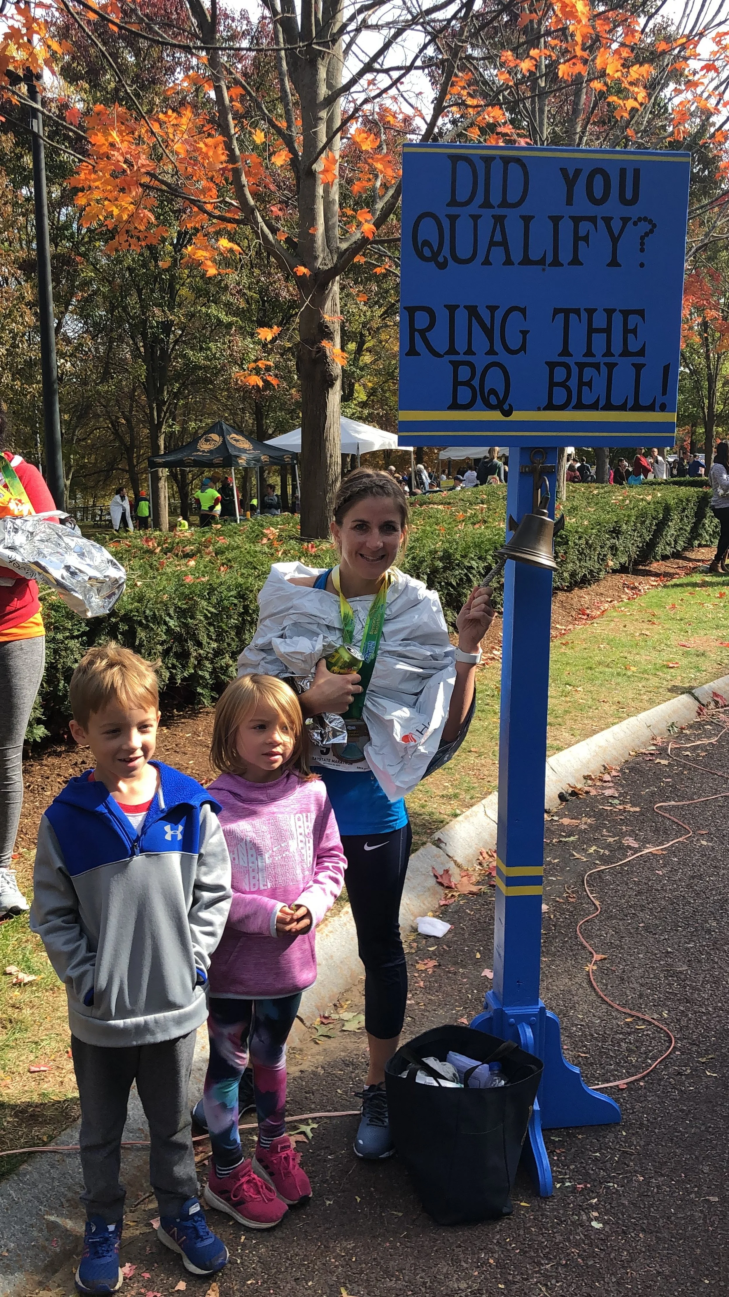 Melissa with kids ringing the Boston Marathon qualifier bell