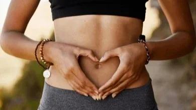 woman-stomach-hand-heart-outdoor-260nw-2313569093.webp