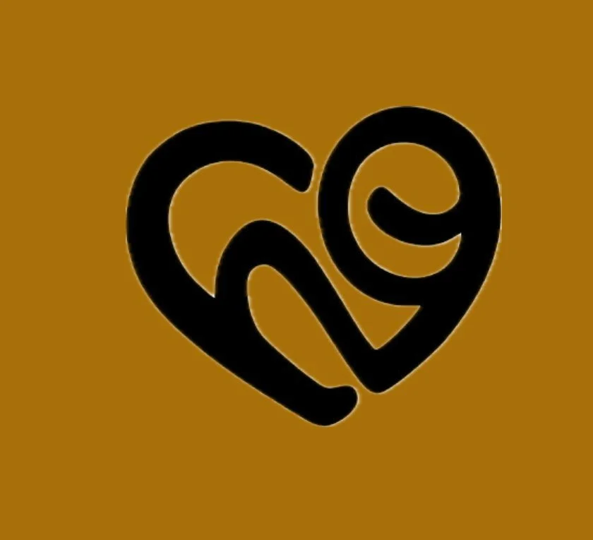 A black, stylized heart shape on a brown background, with a swirling design inside.