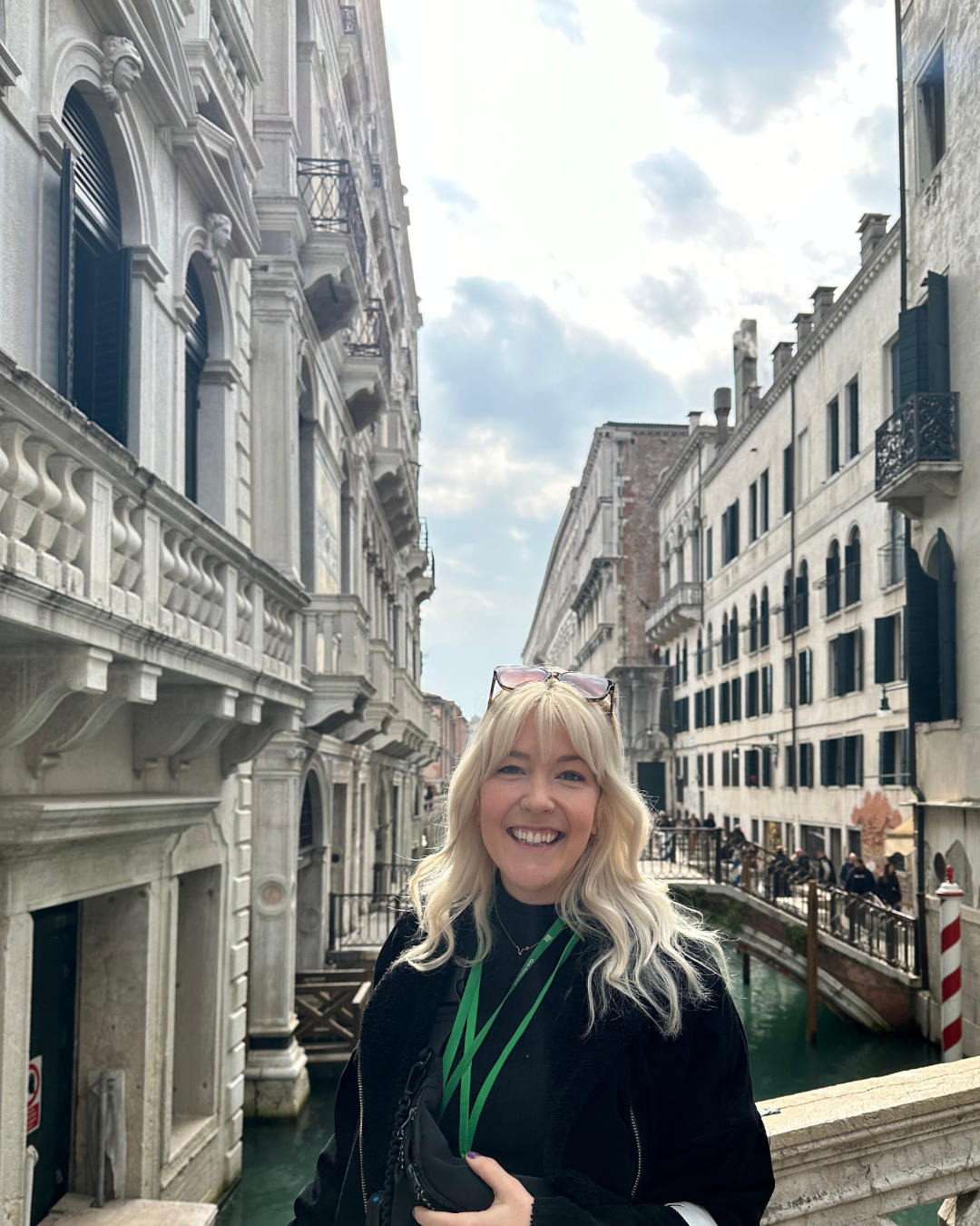 An image of Becky standing on a bridge overlooking a canal in Venice