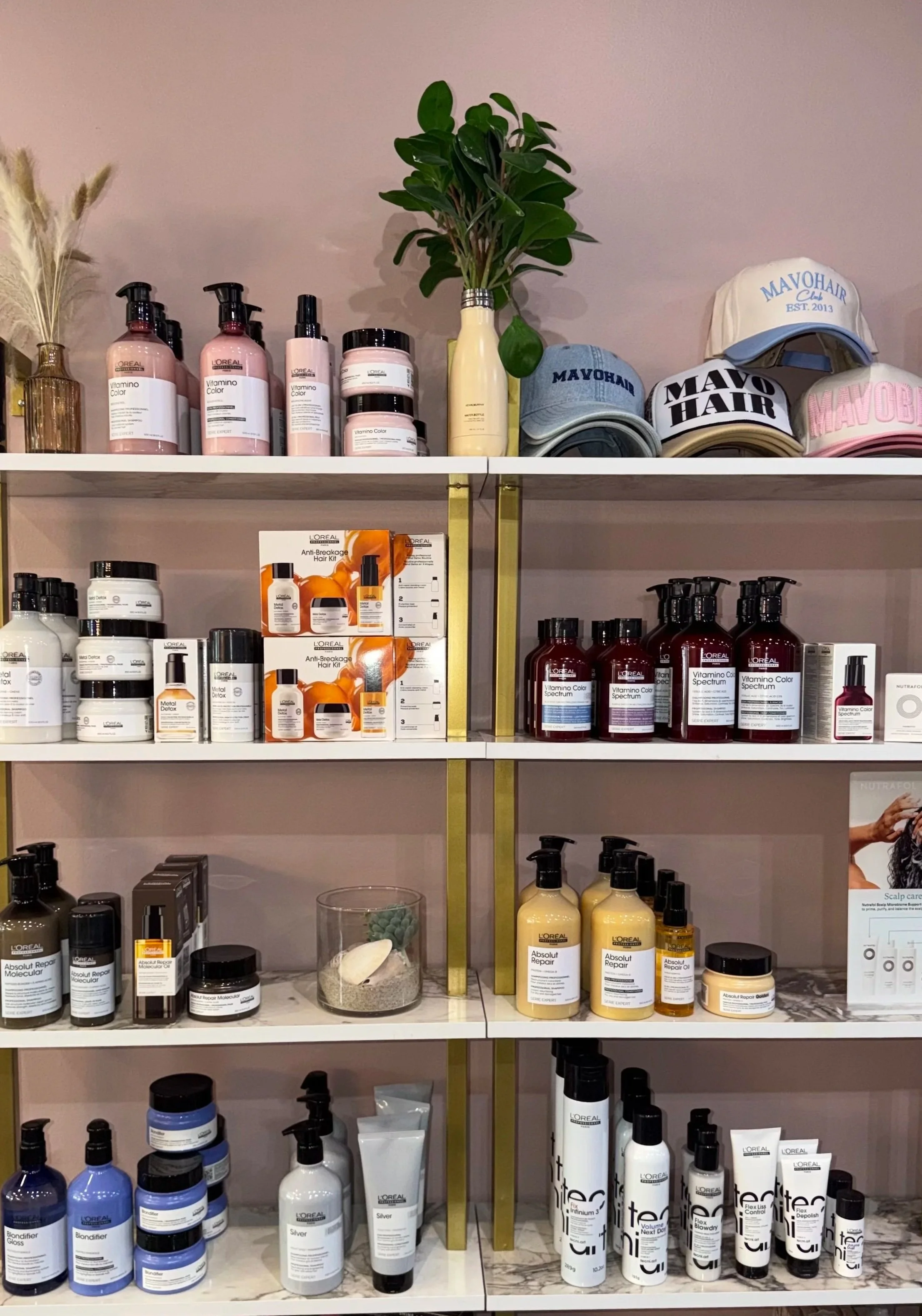 Professional haircare products displayed on retail shelves inside MaVo Hairlounge