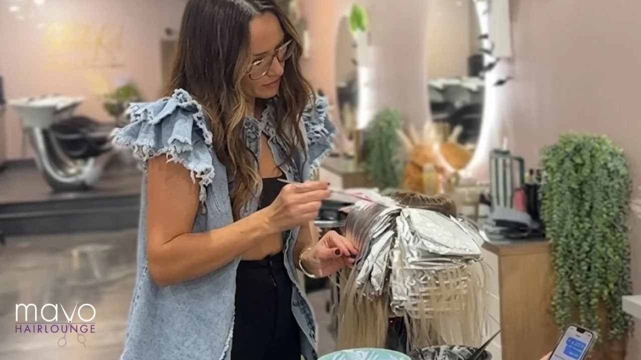 Stylist coloring a customer's hair