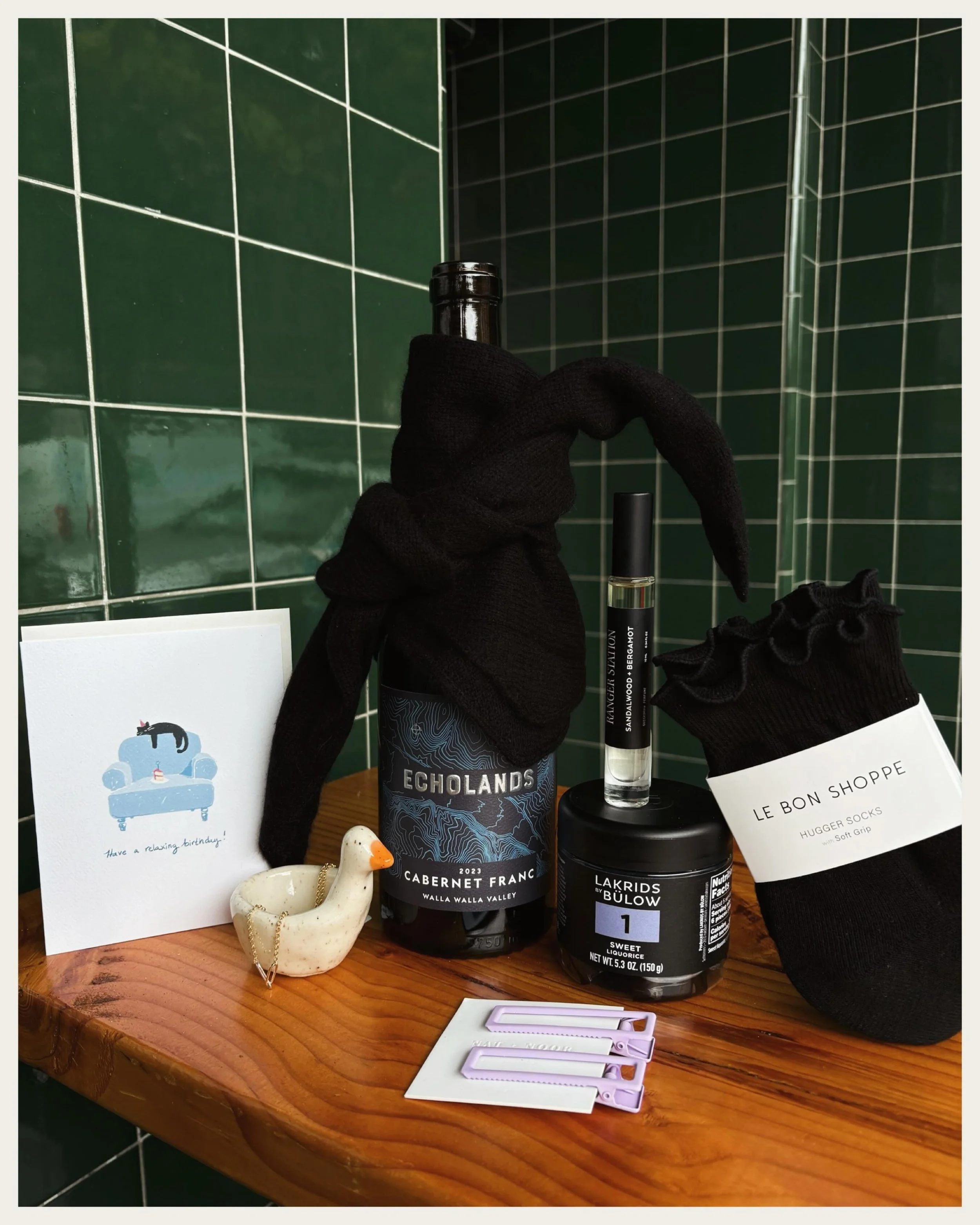 September Inspirations. Cashmere bandanas, cozy chic socks, licorice, Cab Franc for the temperature drop and a cutie goose for their nightstand 🖤