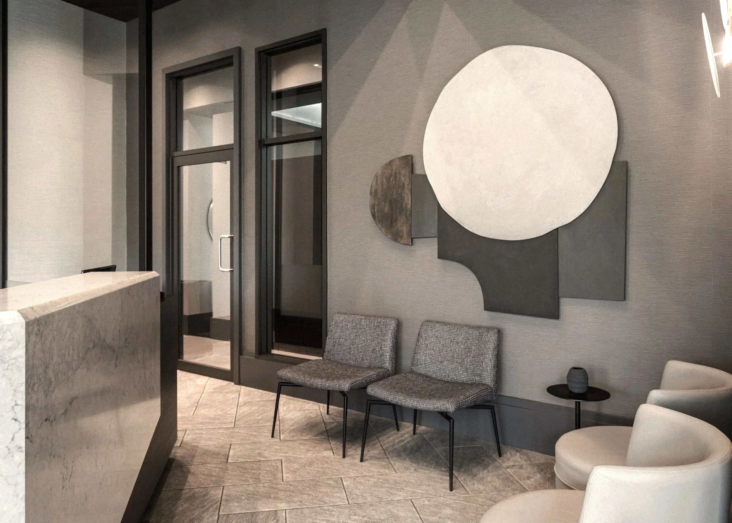 Modern waiting area with two gray chairs, a small black side table with a gray vase, and beige armchairs, decorated with abstract wall art and textured gray wall panels.
