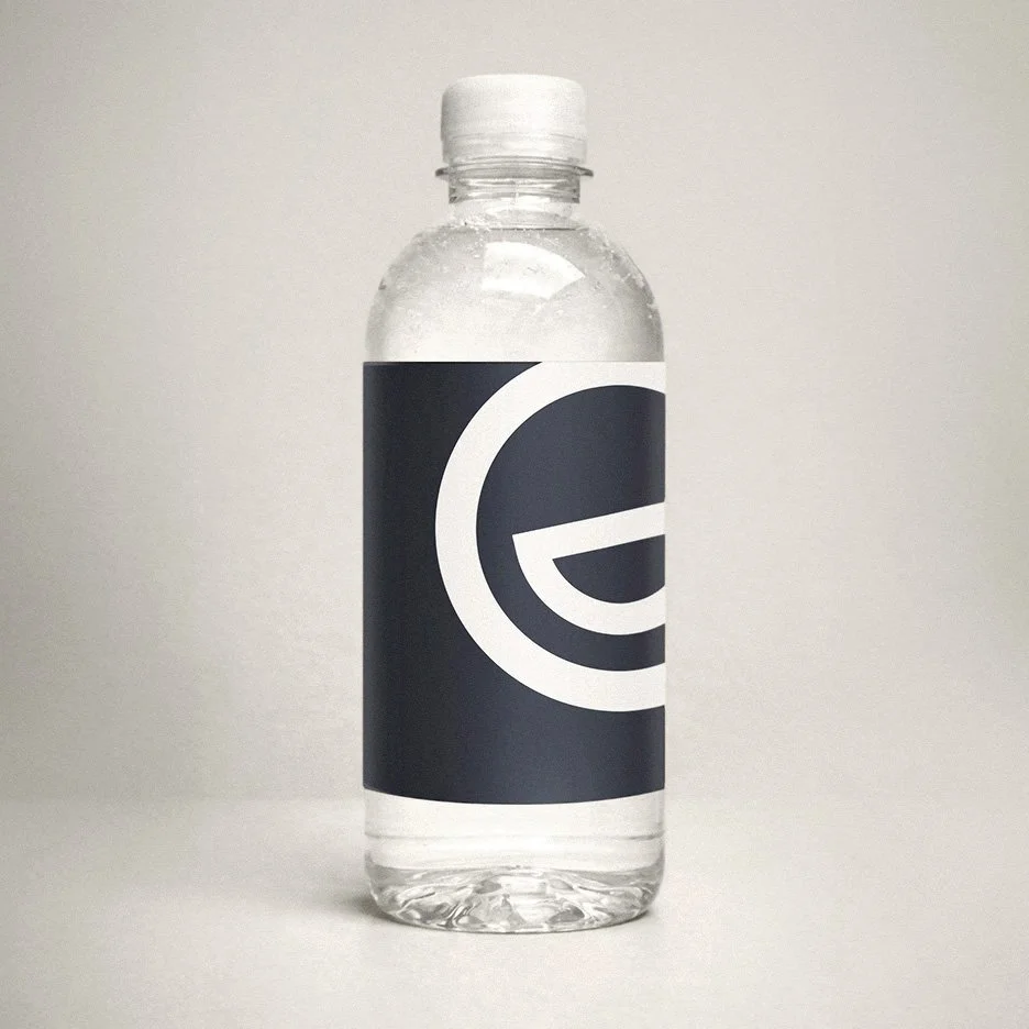 A clear plastic water bottle with the Morgan Gate Dental logo
