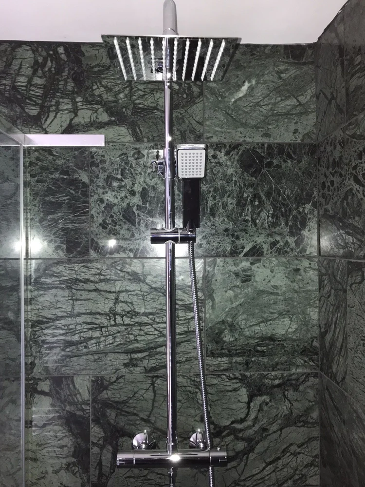Chrome thermostatic shower with a square rainfall head and handheld shower, installed in Urmston.