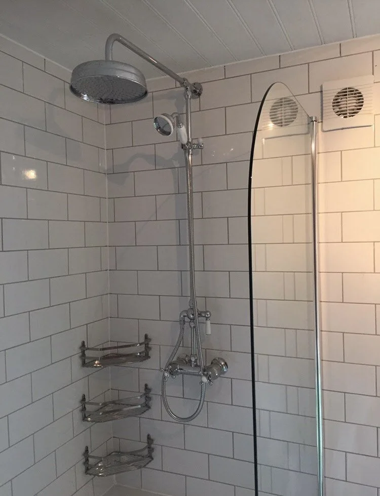 Shower installation in Manchester with modern rainfall shower head and mixer setup