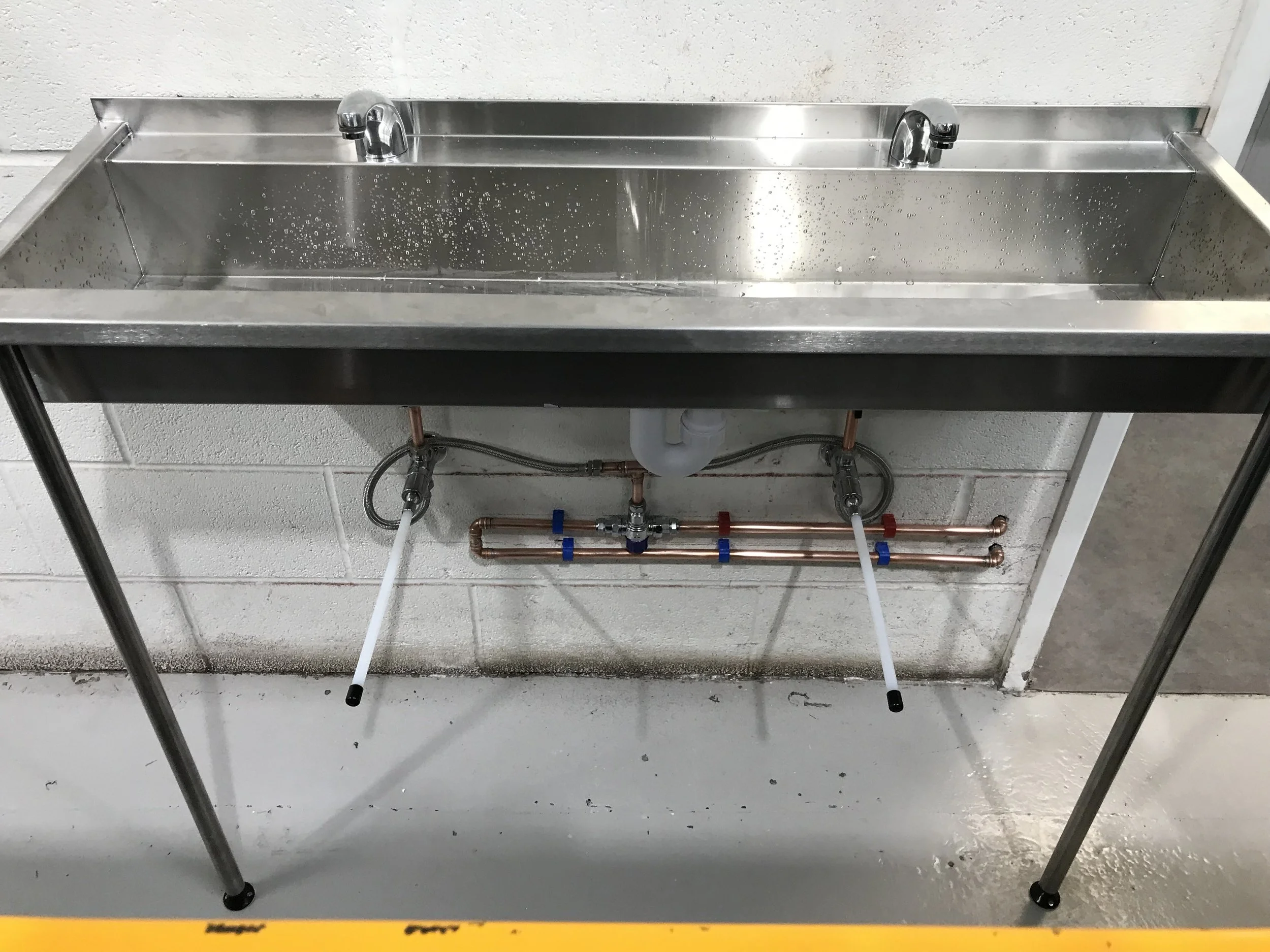 Commercial hand wash trough installation with knee operated taps completed in Trafford Park Manchester